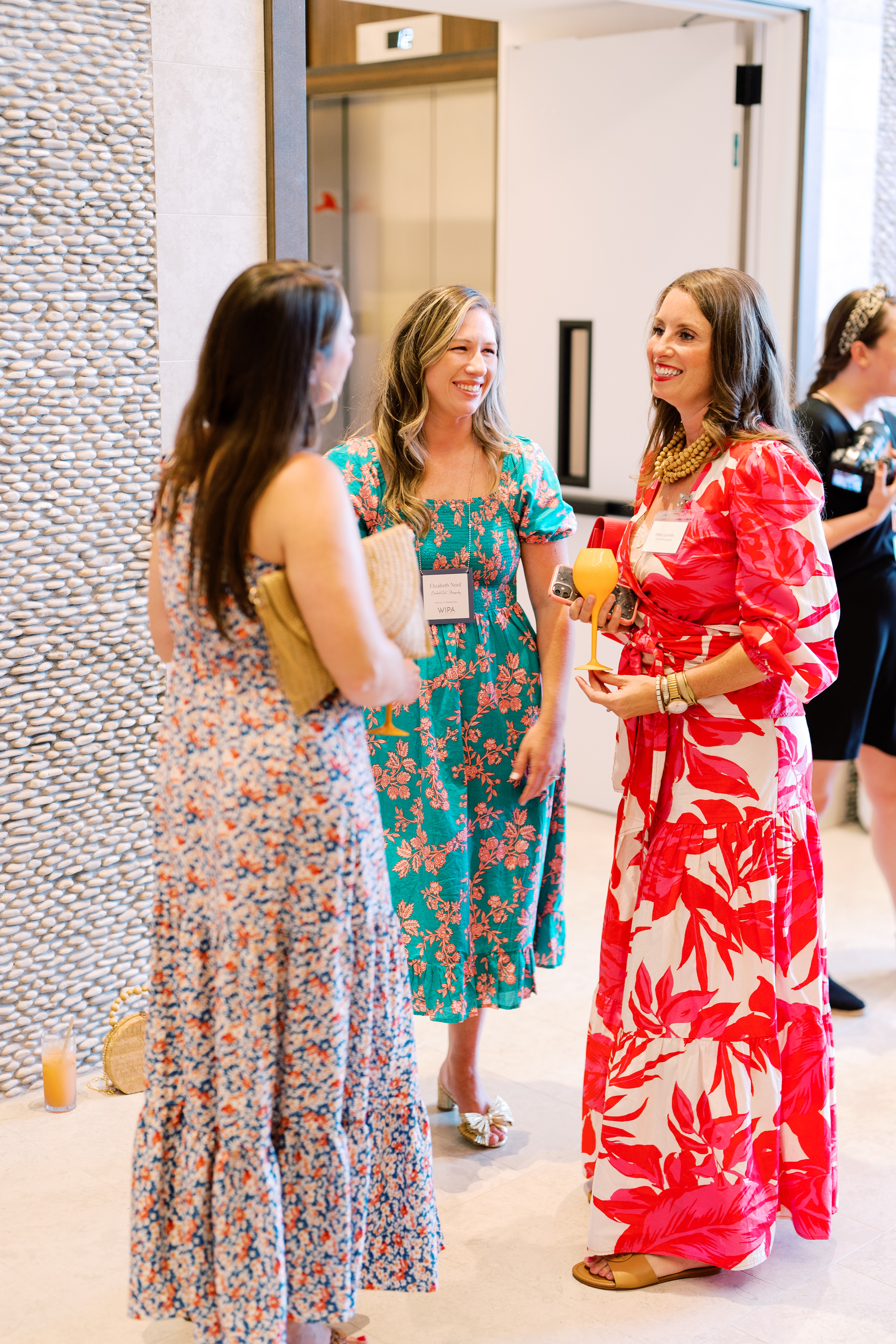 Three women talking during cocktail hour.