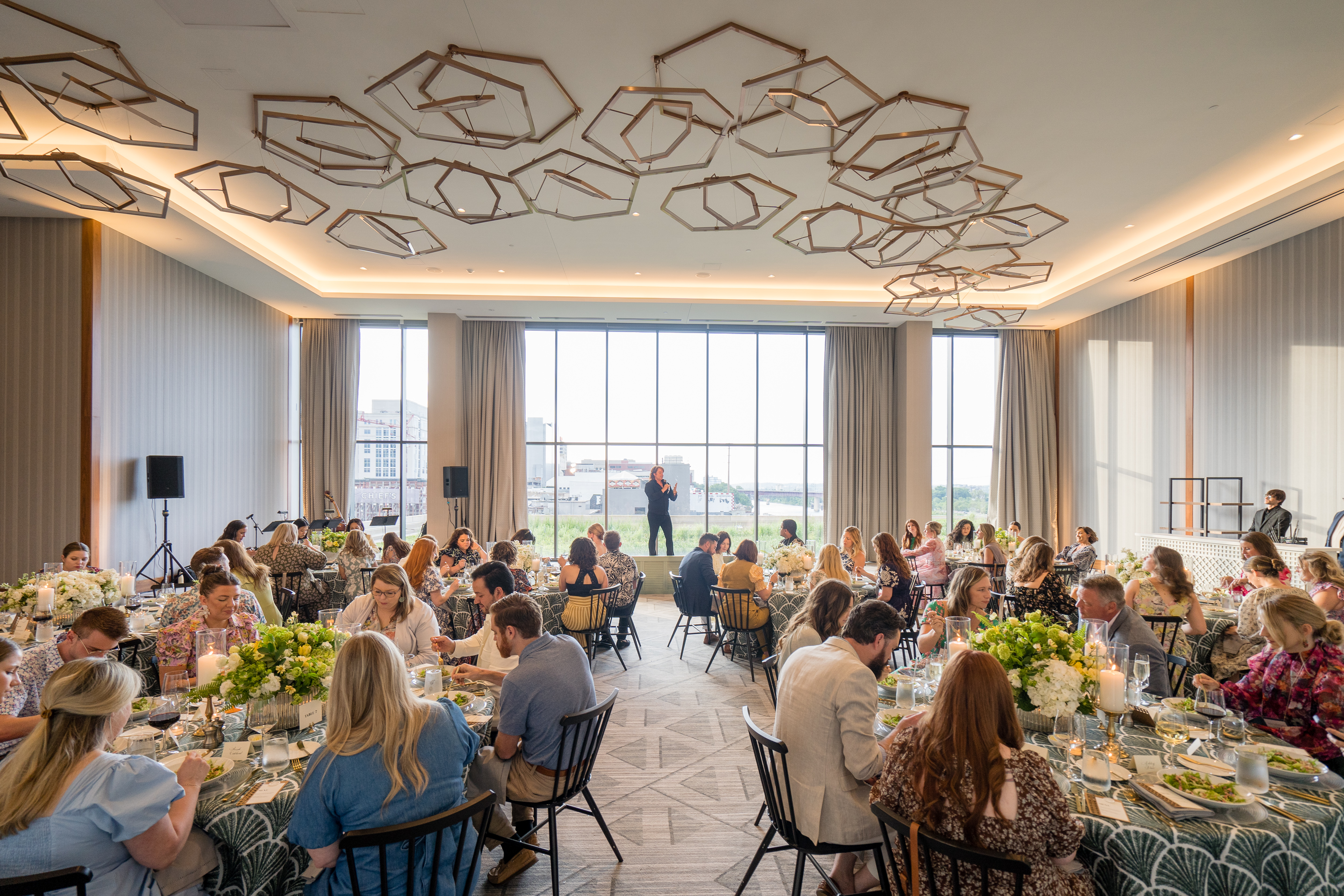 Guests dining in grand ball room. 