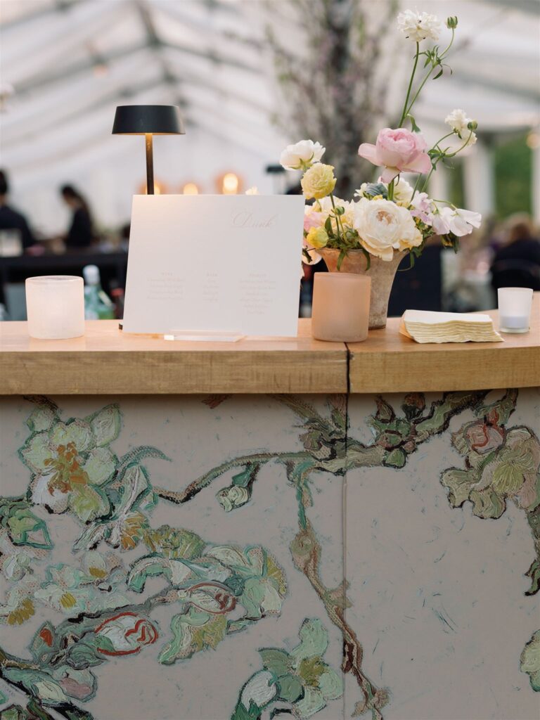 Cocktail Bar lined with floral print. at outdoor reception area.