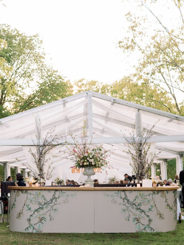 Cocktail Bar lined with floral print. at outdoor reception area.