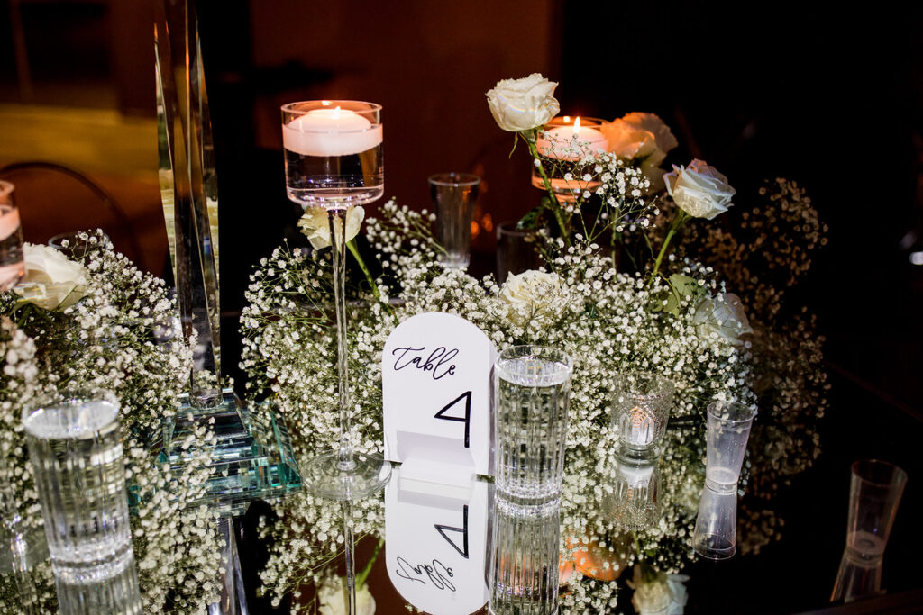 Arched table number signage in center of tablescape.
