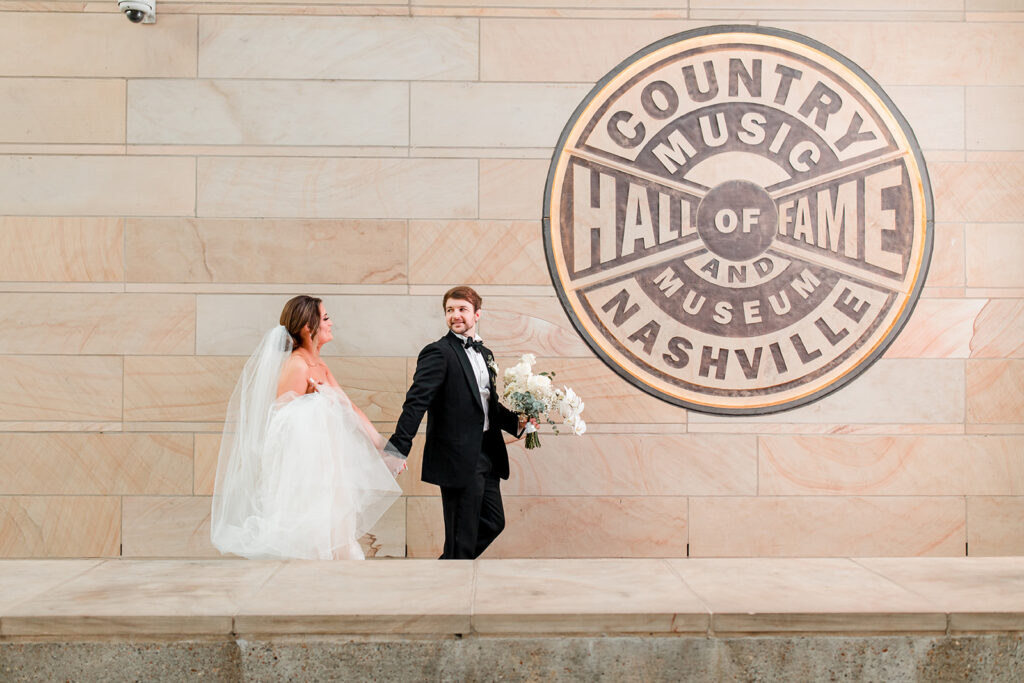 Bride and Groom walking in front of Country Music Hall of Fame