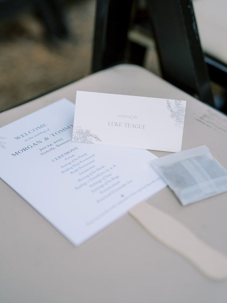 Ceremony program, placecard, and bag of lavender on seat.