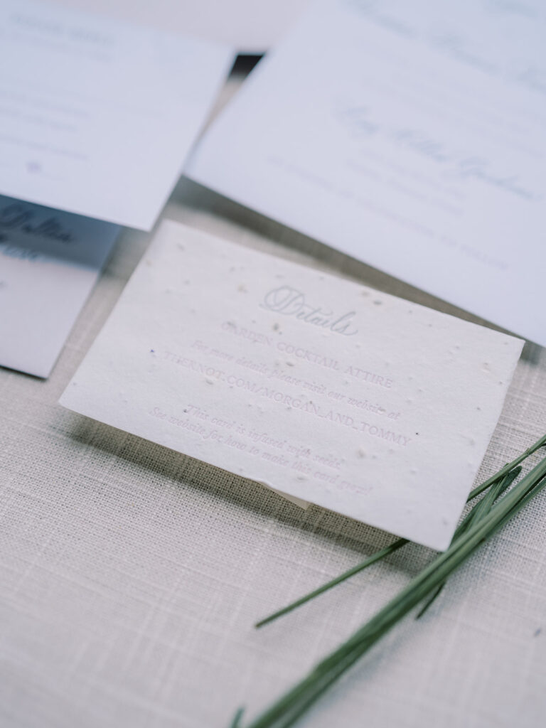 Invitation suite with lavender stems beside it.