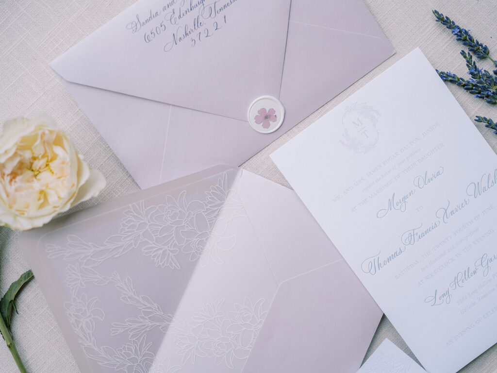 Invitation suite including envelope with wax seal.