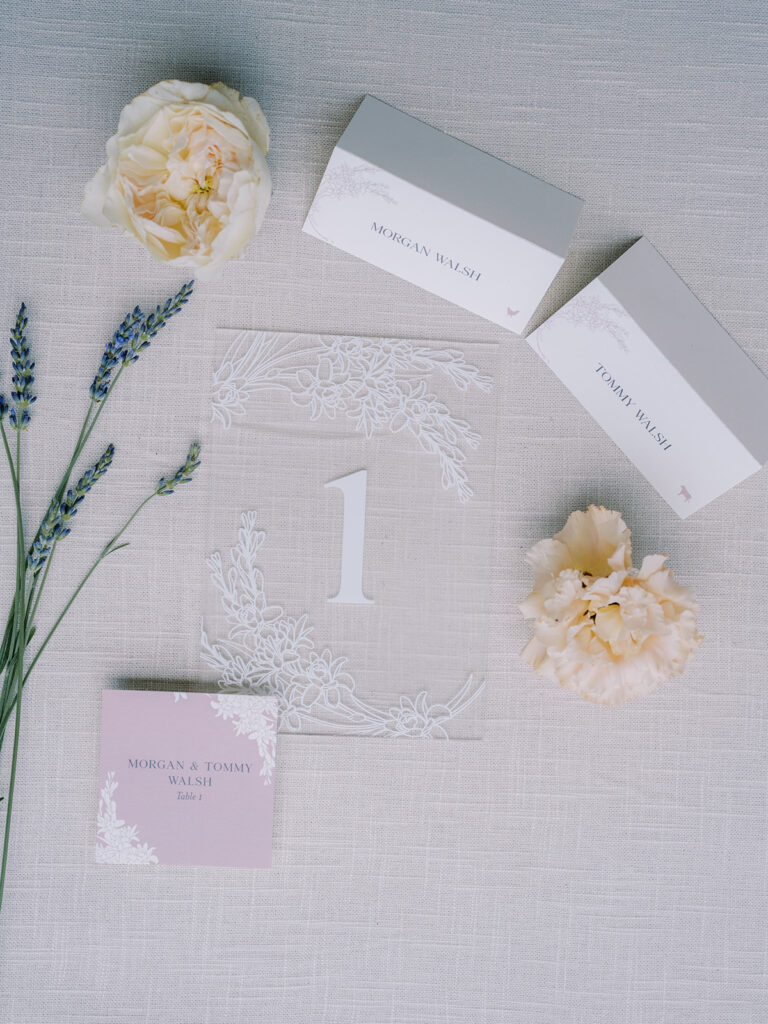 frosted acrylic table number, placecards, and escort cards. Styled with florals and lavender.