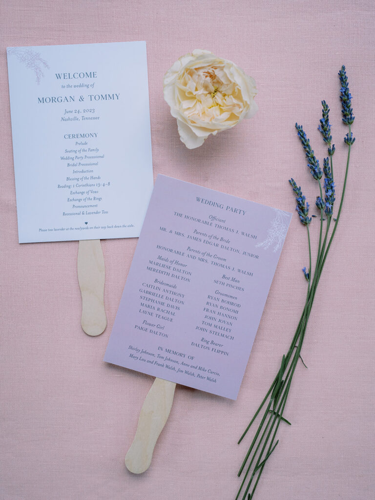 Ceremony programs with wooden handles styled with flower and lavender.