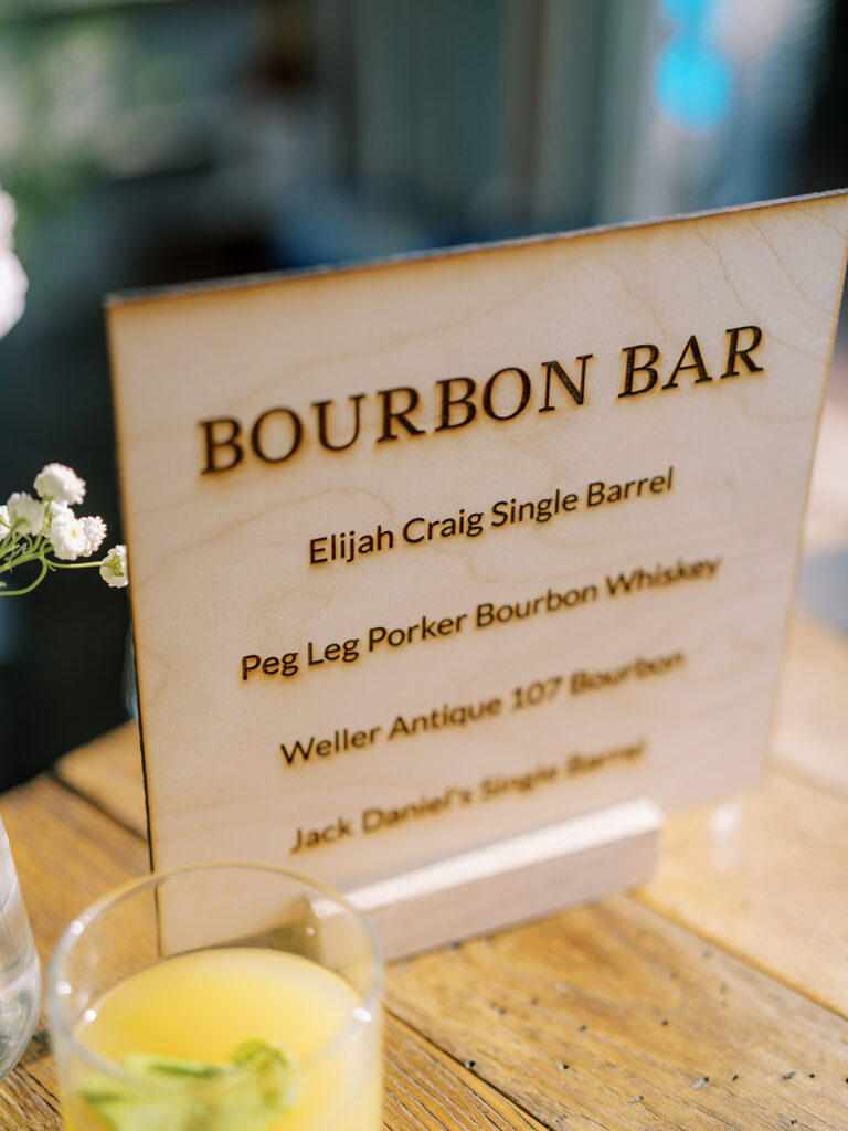 Engraved wooden bar sign on top of bar.