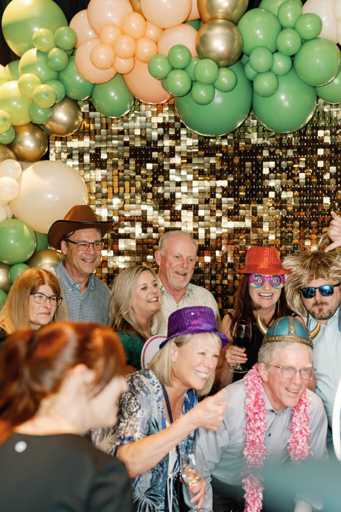 Guests gathered in front of decorated photo booth