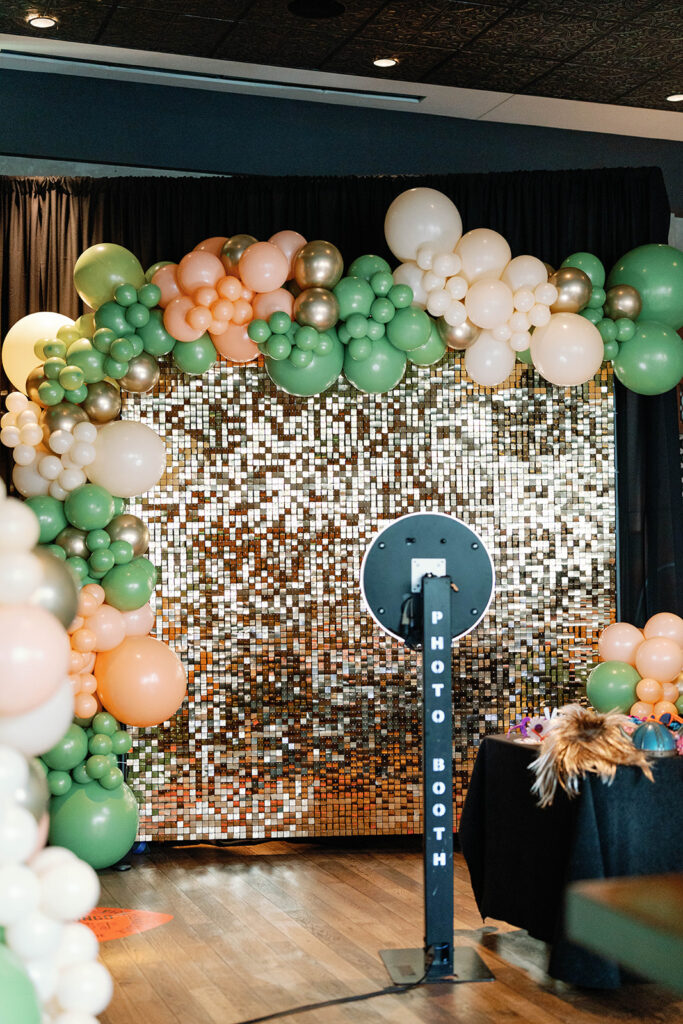 Photo booth with shimmer and balloon arch backdrop