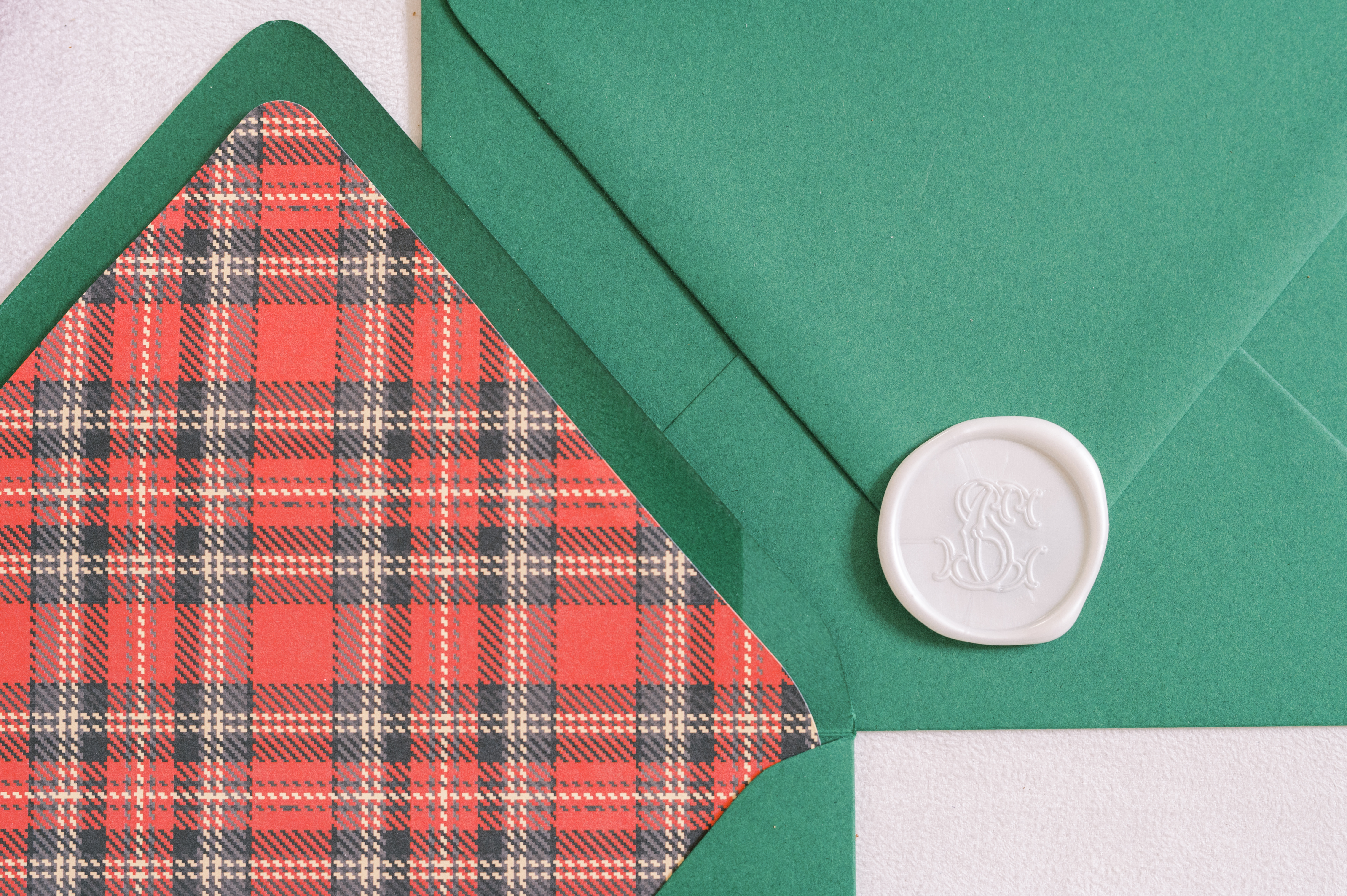 Plaid-lined green envelope with wax seal