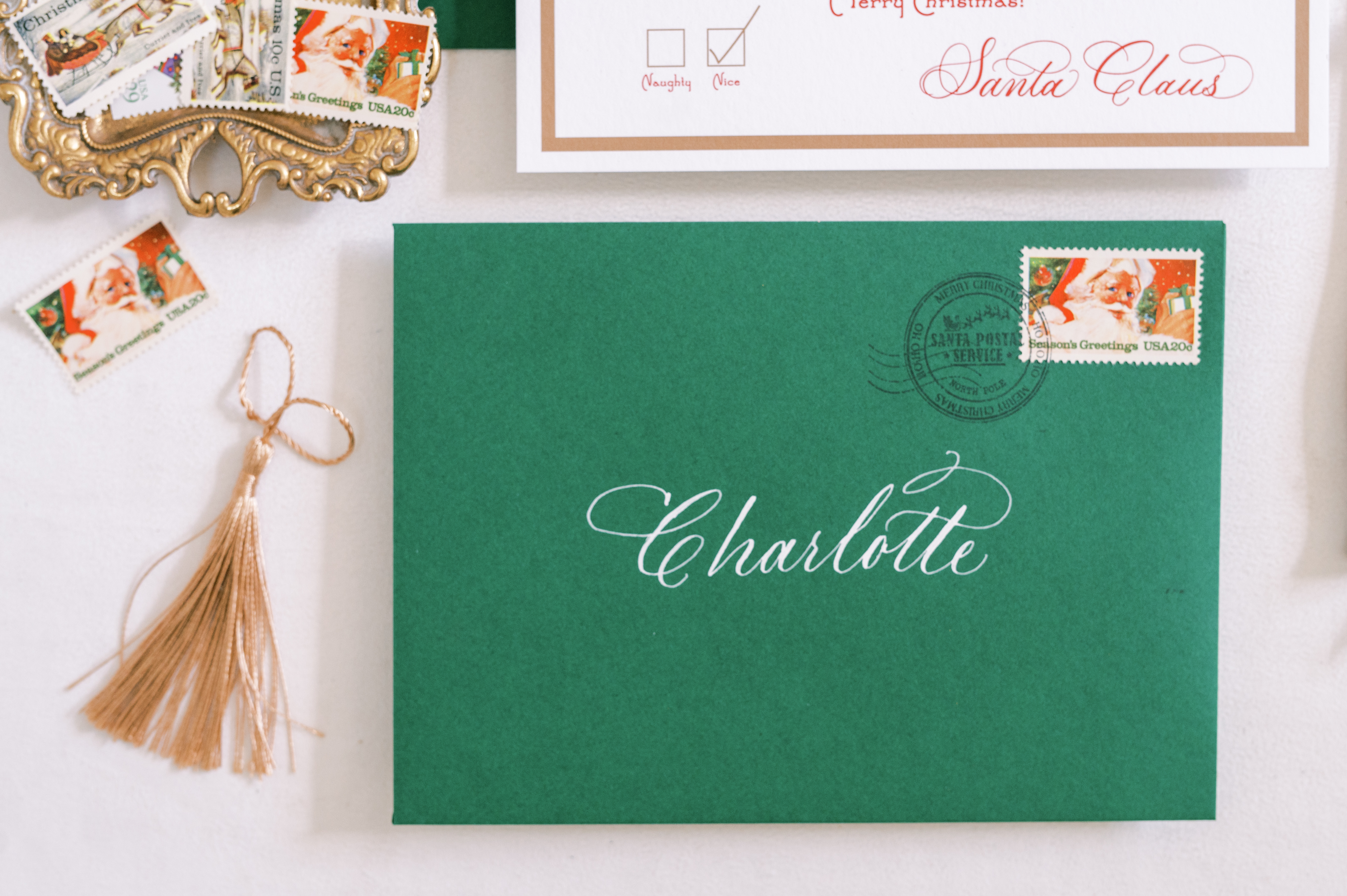 Green envelope with calligraphy and vintage holiday stamp.