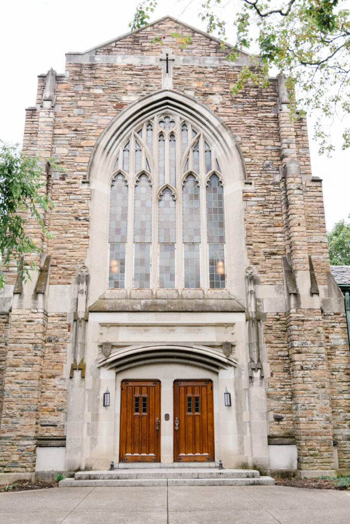 Outside image of Scarritt-Bennett church showcasing front double doors and stained glass windows.