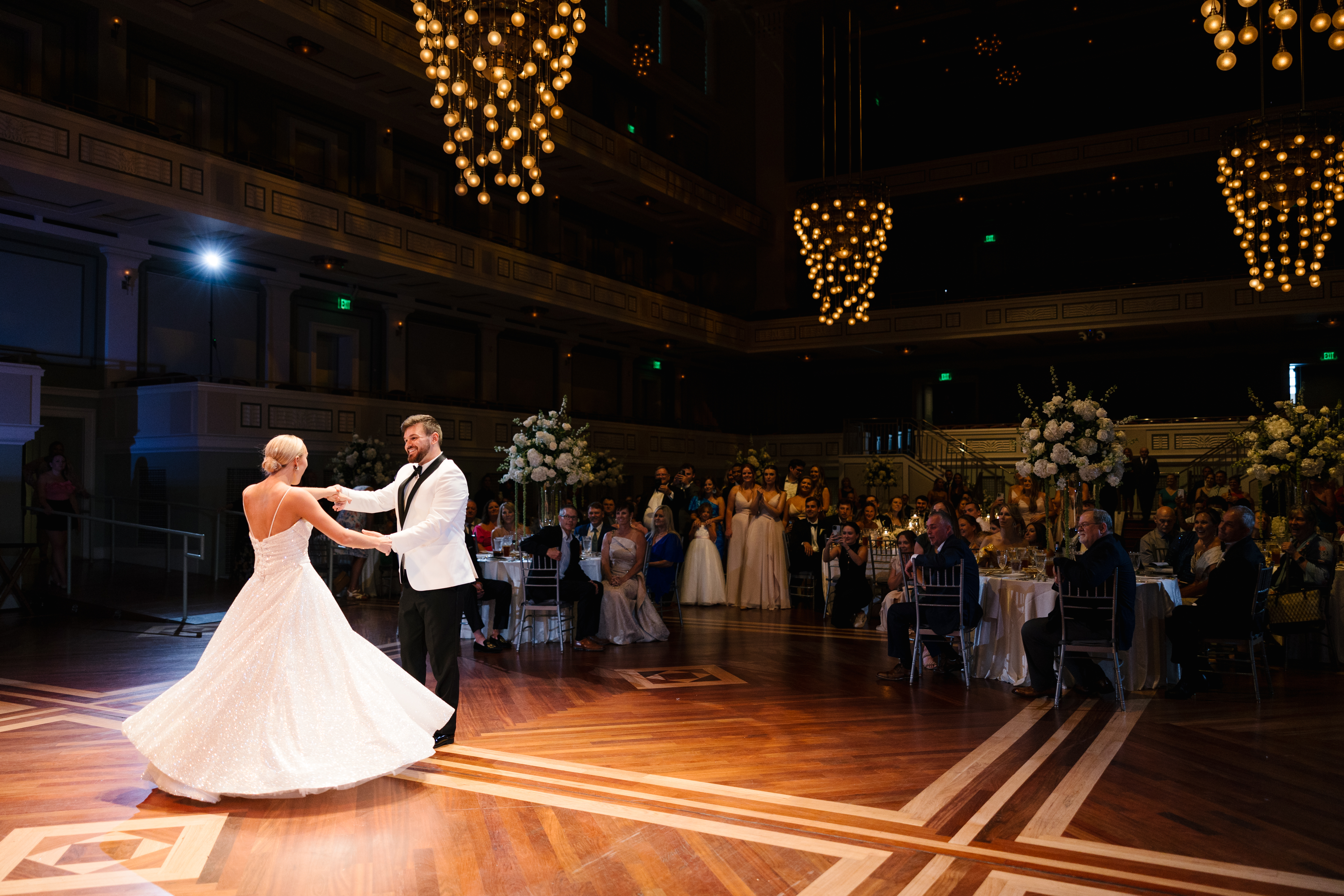 Bride and Groom dancing on the dance floor as guests look on. 