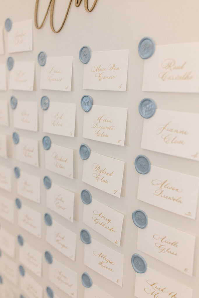 Escort cards attached to display with custom wax seals.