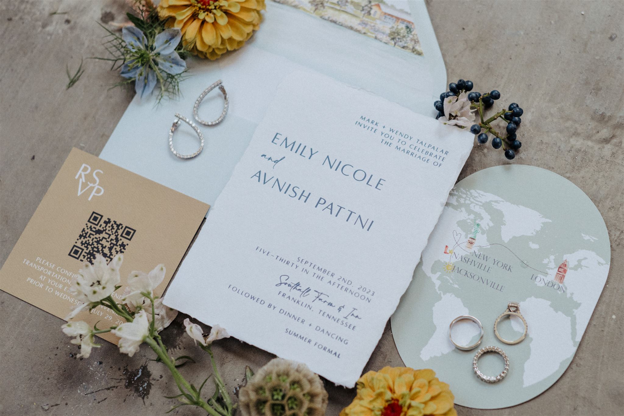 Custom wedding invitation suite. styled with jewelry, florals, and custom paper goods.