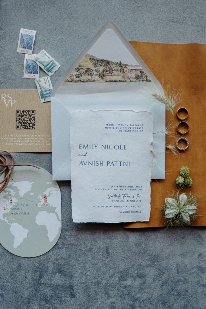 Custom wedding invitation suite. styled with jewelry, florals, and custom paper goods.