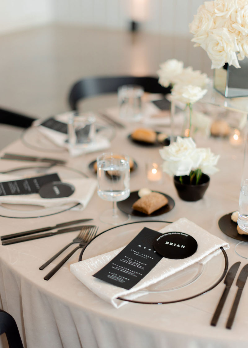 Menus and custom place cards by White Ink Calligraphy shown as part of wedding table decor