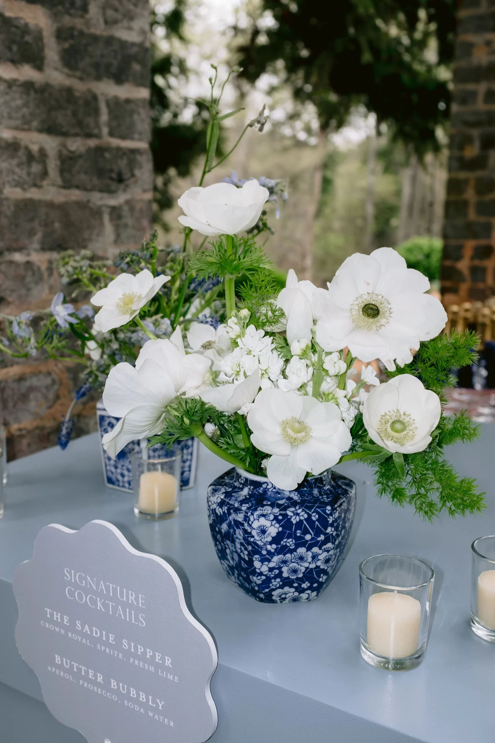 wedding bar sign and florals decorate bar area 