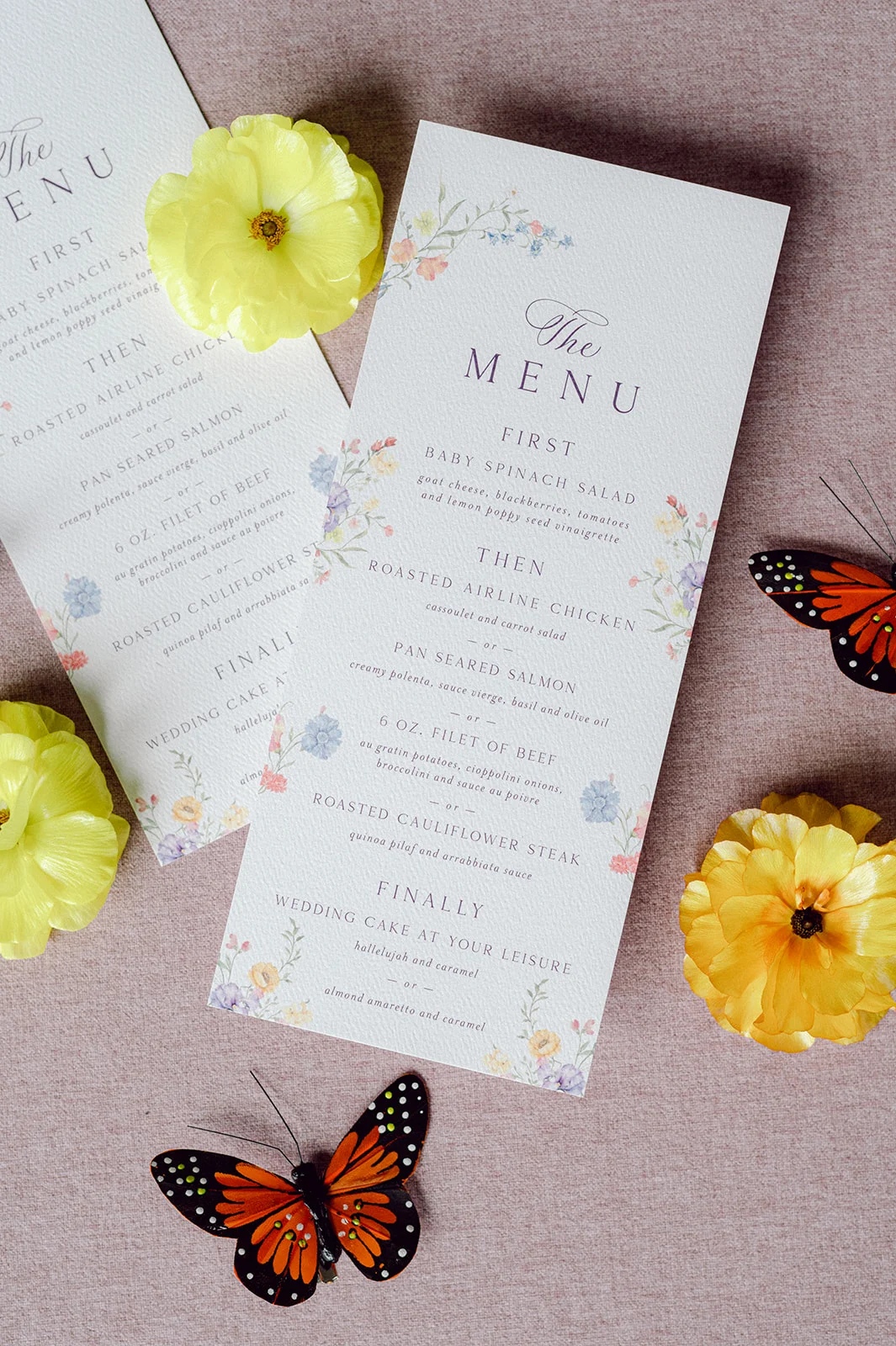 Custom wedding menus with floral design on sides.