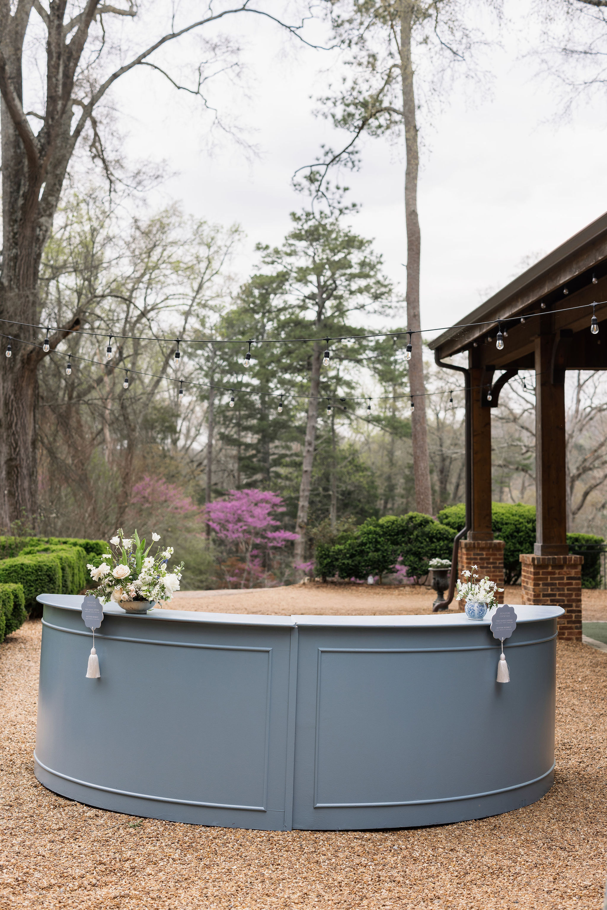 custom blue bar signs attached to bar with fun white tassel. 
