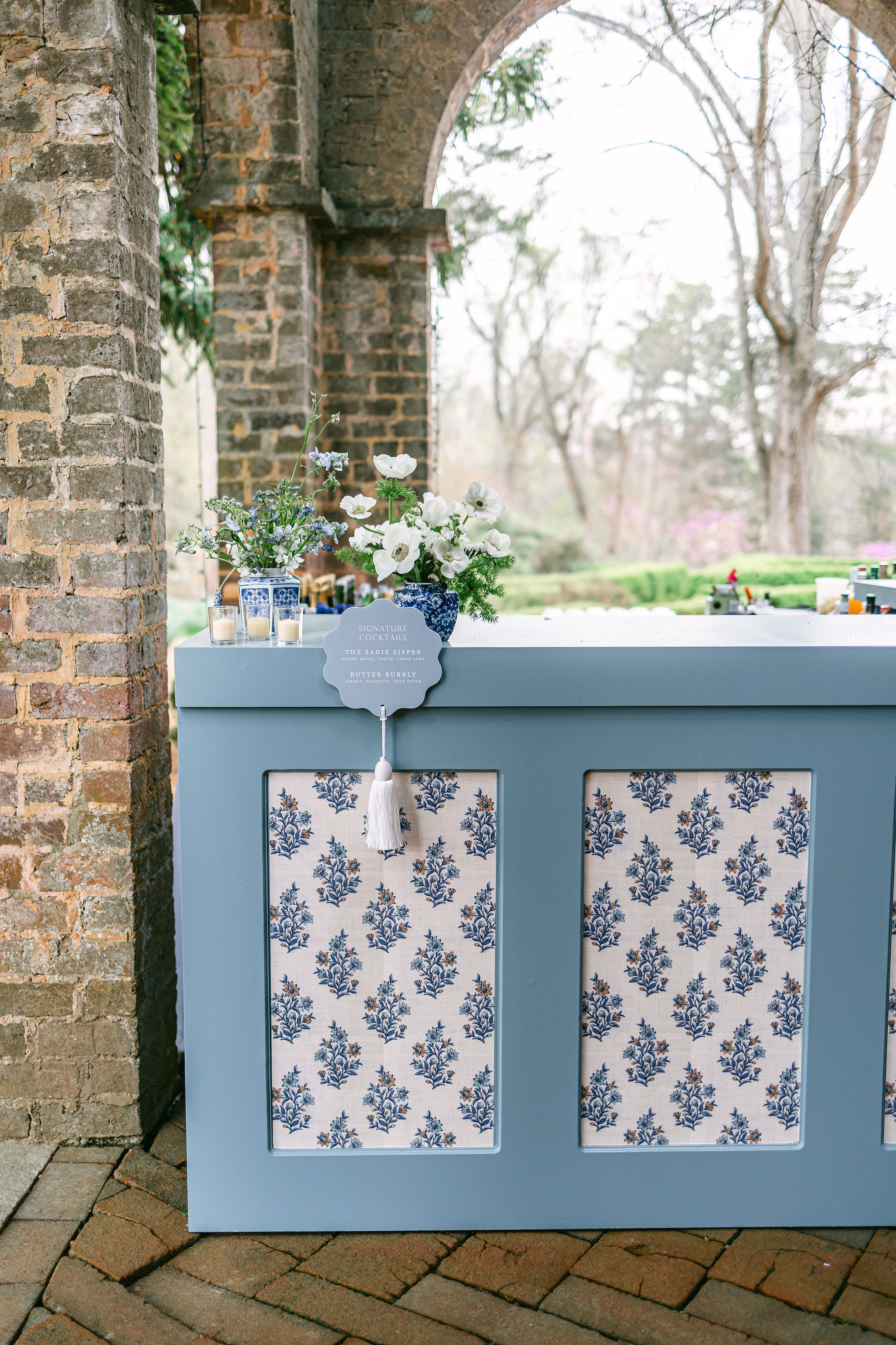 custom blue bar signs attached to bar with fun white tassel. 
