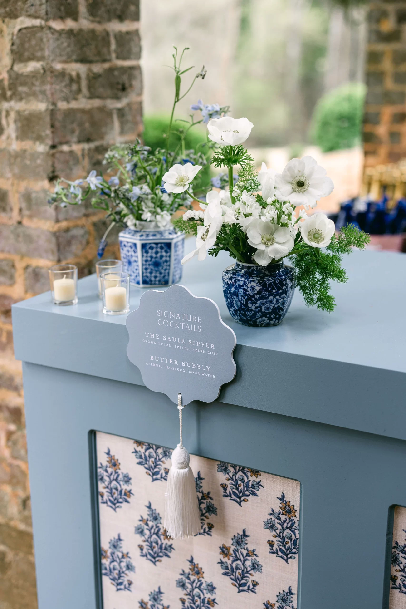 custom blue bar signs attached to bar with fun white tassel. 
