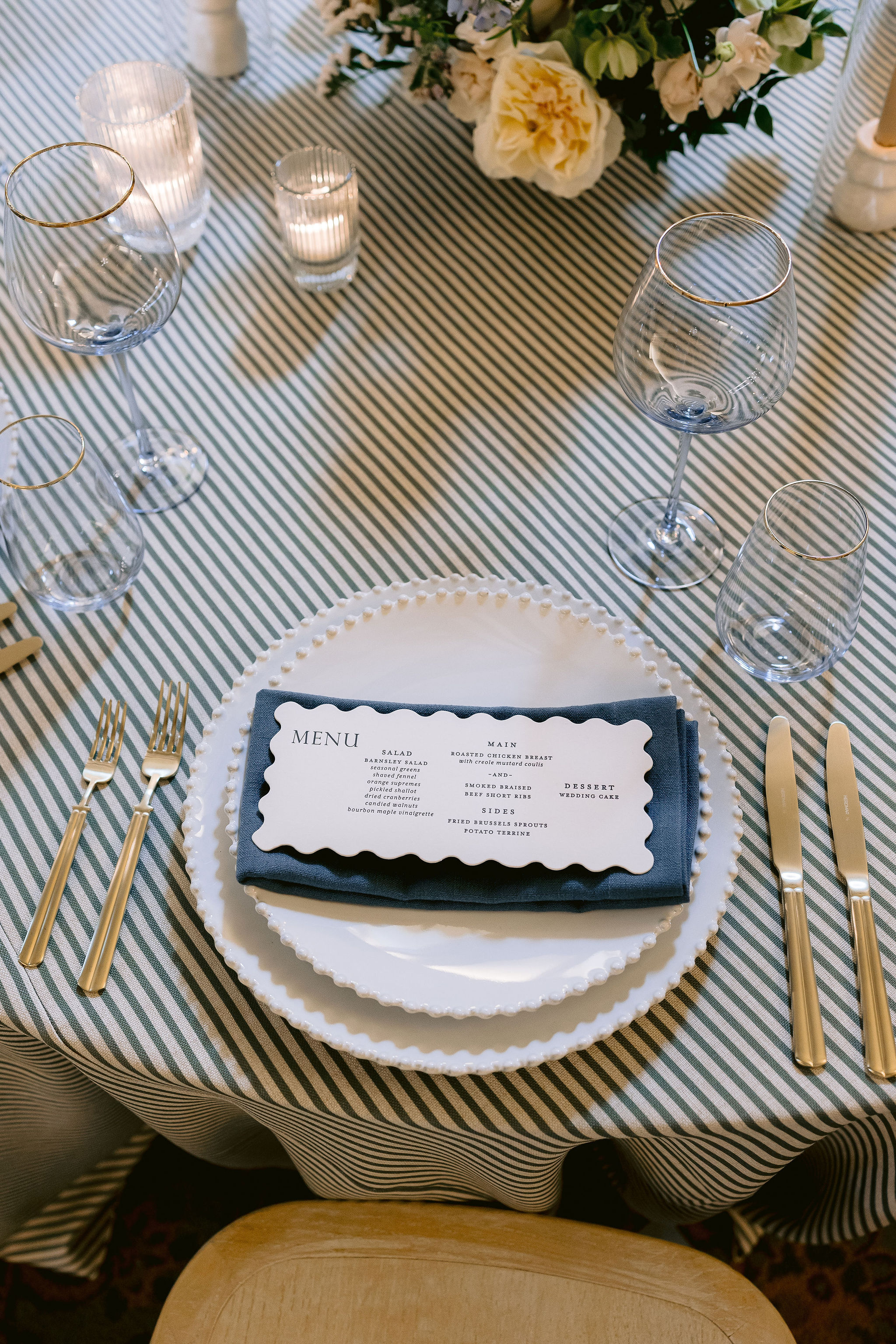 custom die-cut menu on top of white plates and napkins.
