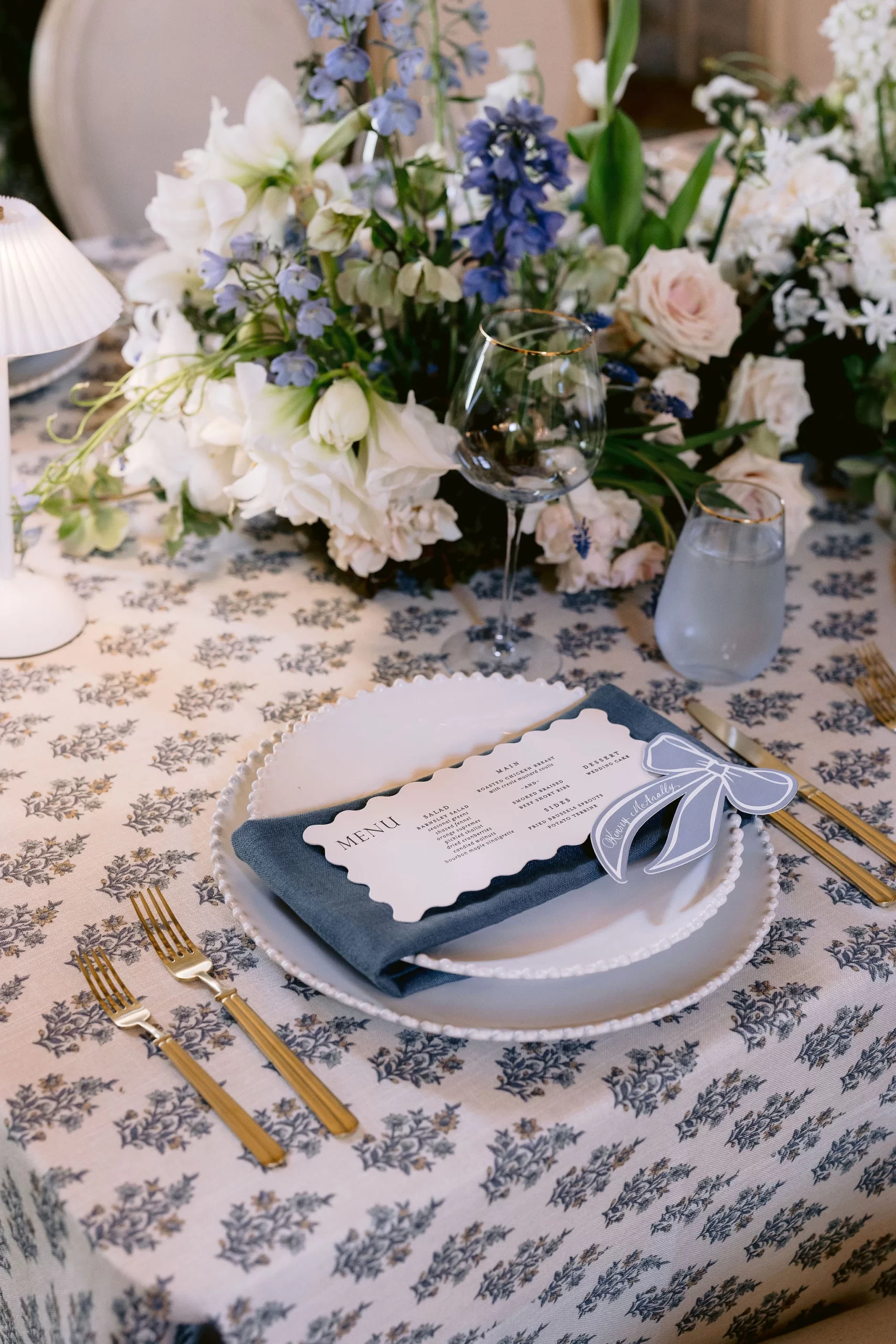 menus and blue ribbon place cards at table setting. 