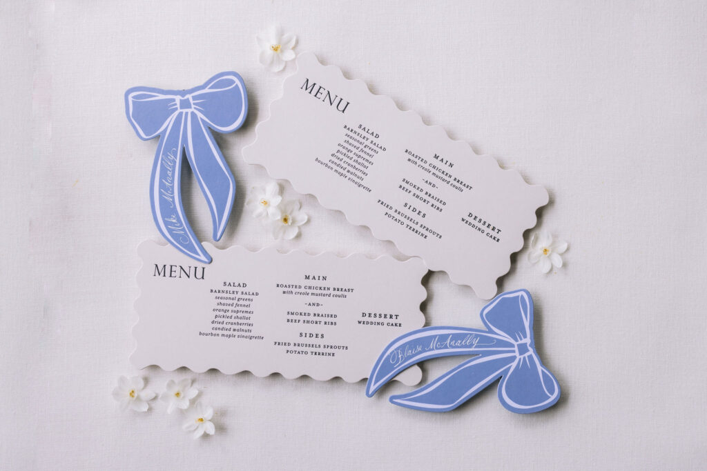 custom die cut menus and blue ribbon place cards.
