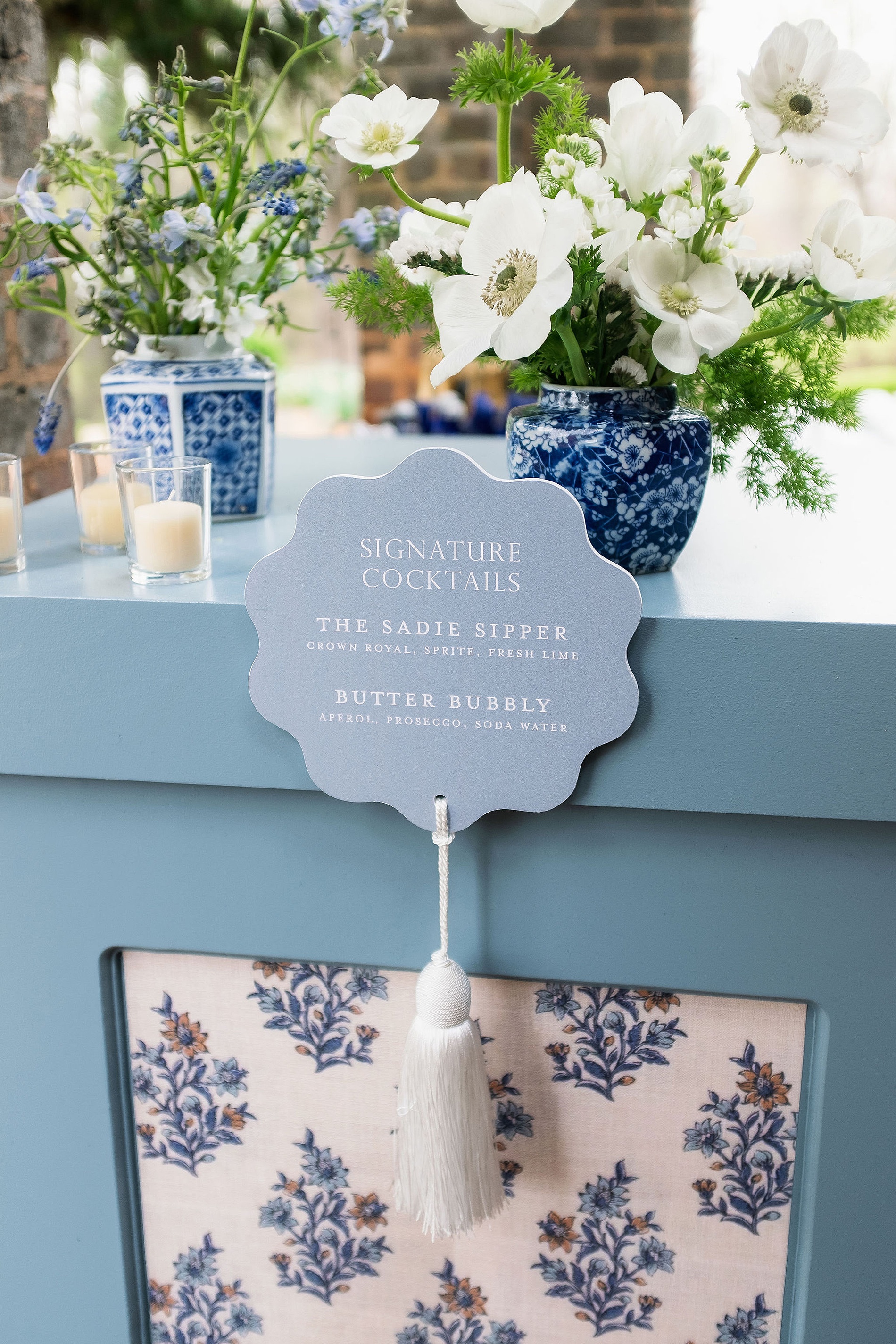 custom blue bar signs attached to bar with fun white tassel. 