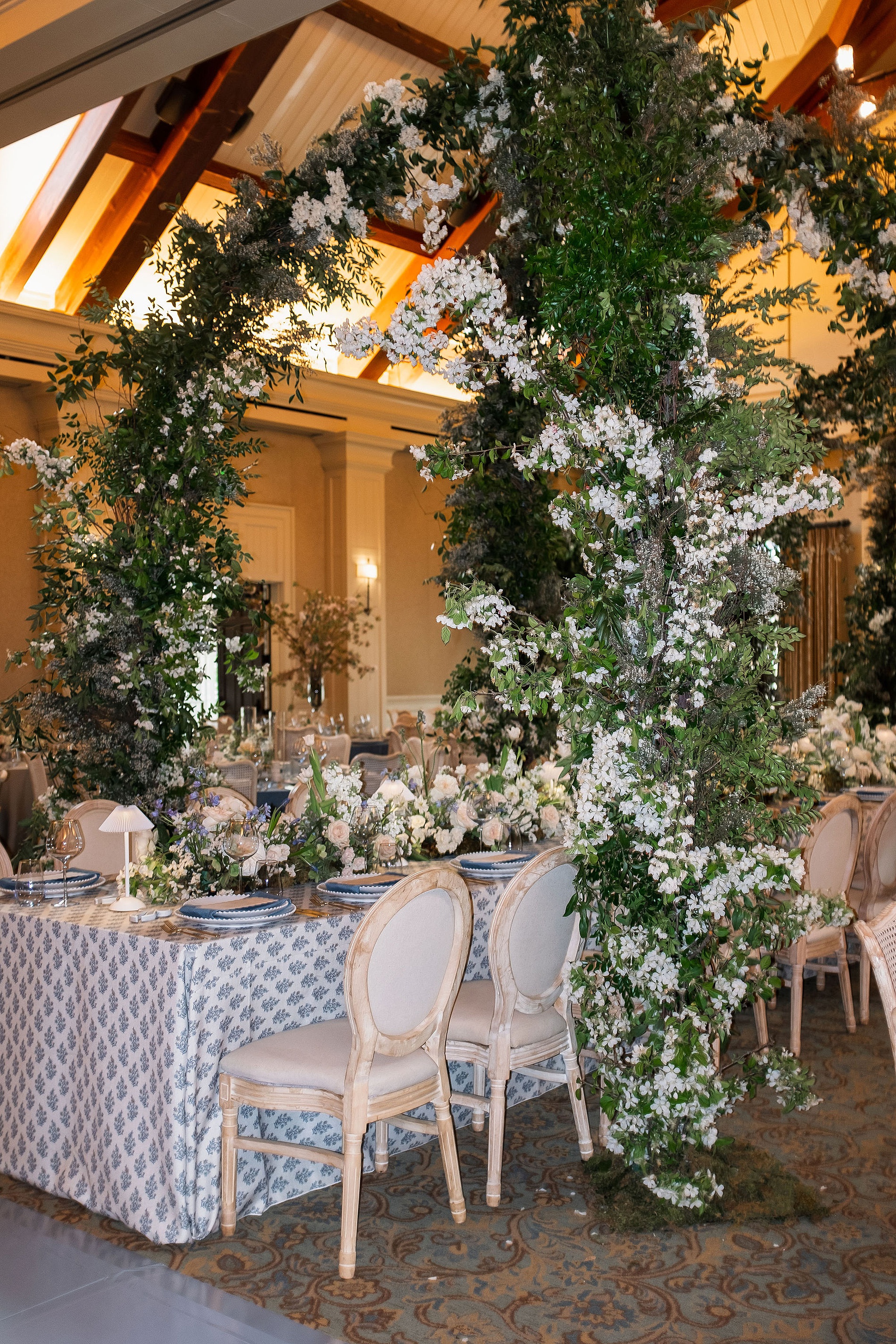 enchanting floral arches surround head table at romantic Georgia wedding reception. 