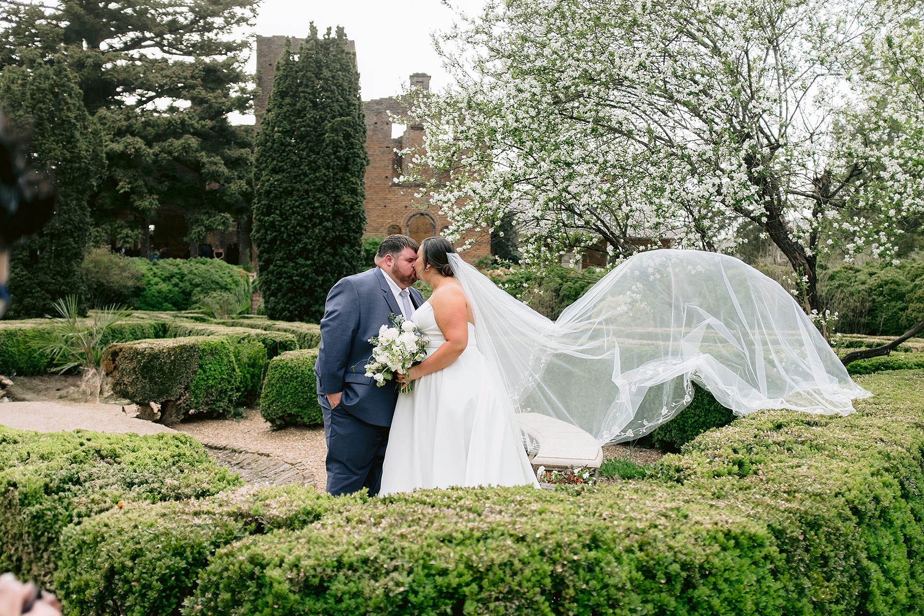 romantic newlywed photos with bride's veil flowing around in the gardens at Barnsley Resort. 
