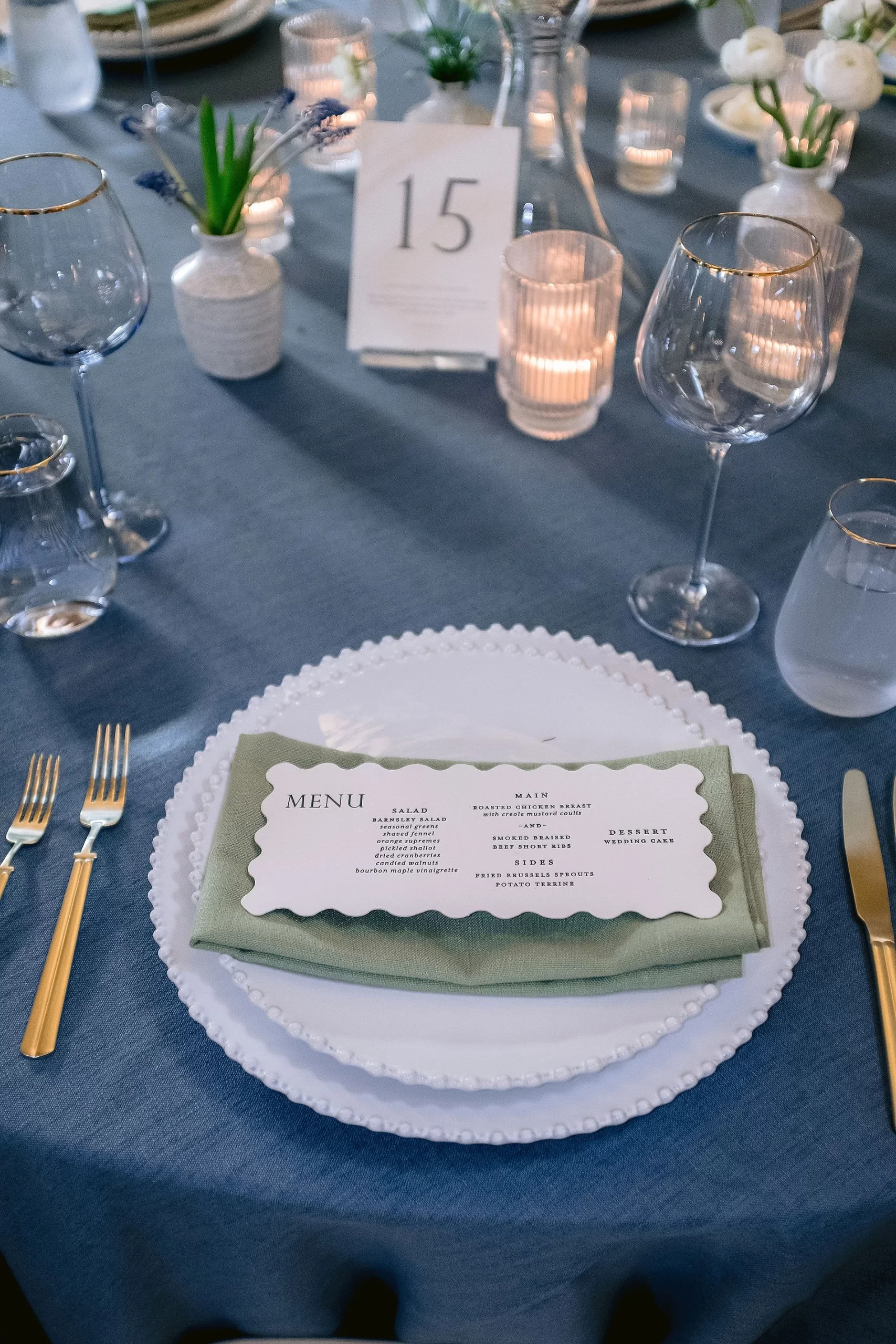 die-cut menu on napkin at place setting with custom table numbers. 
