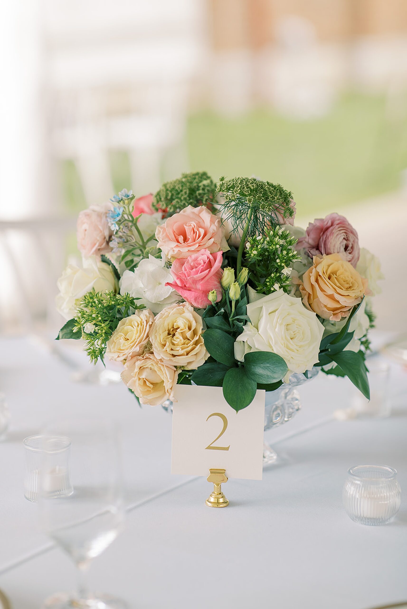 Spring flower centerpieces with gold table numbers