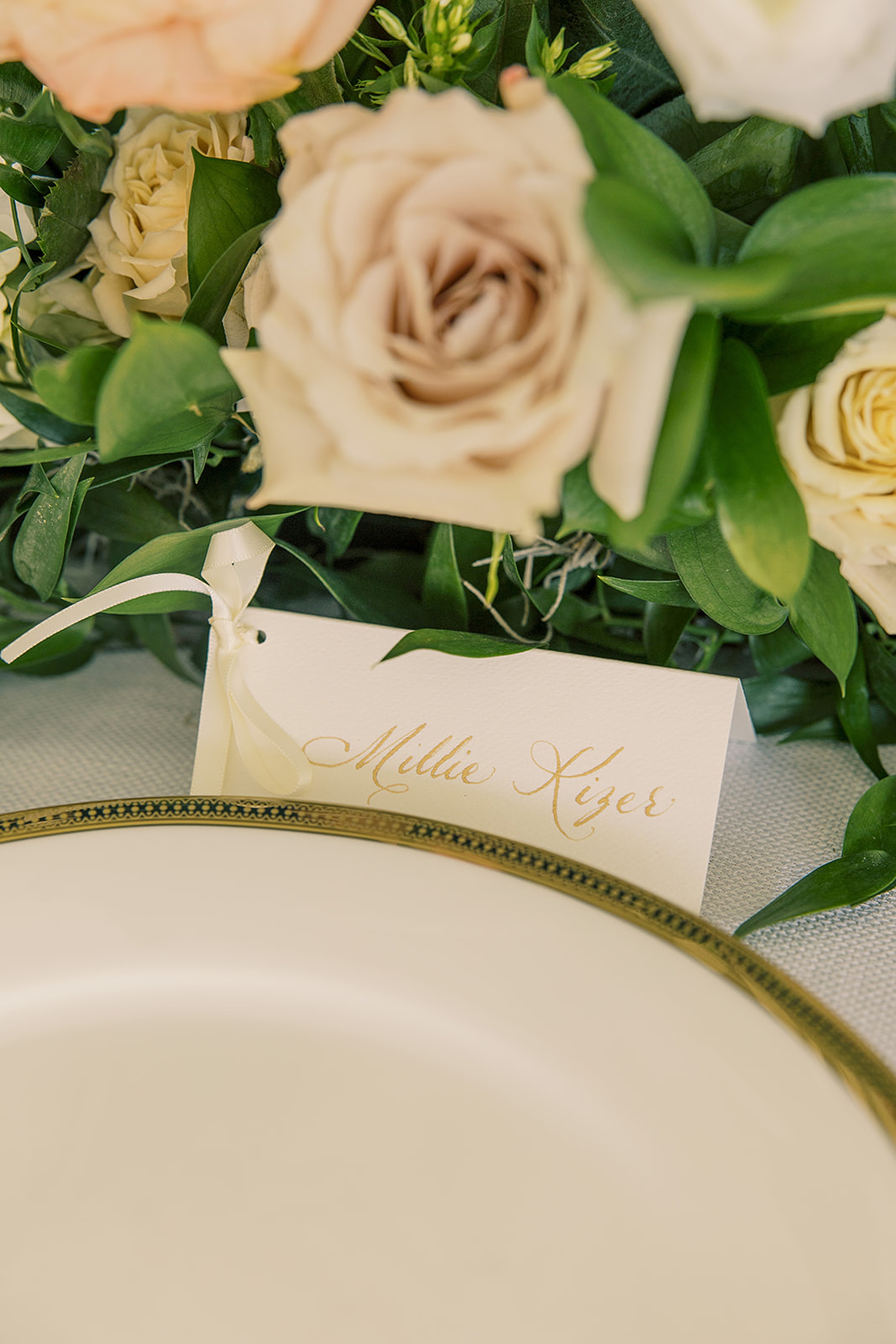 white place cards with gold calligraphy 