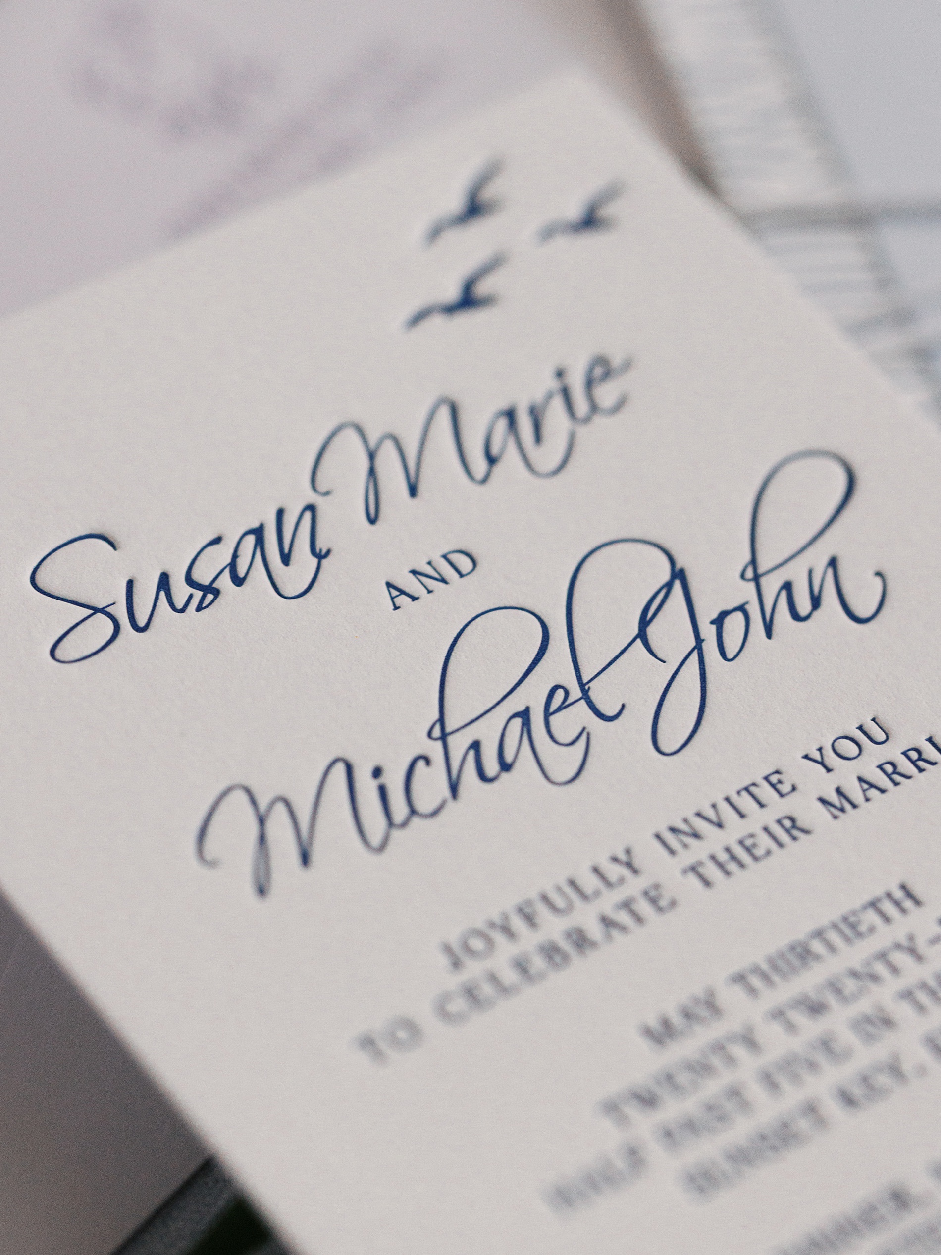 Letterpress invite with blue seagull artwrork