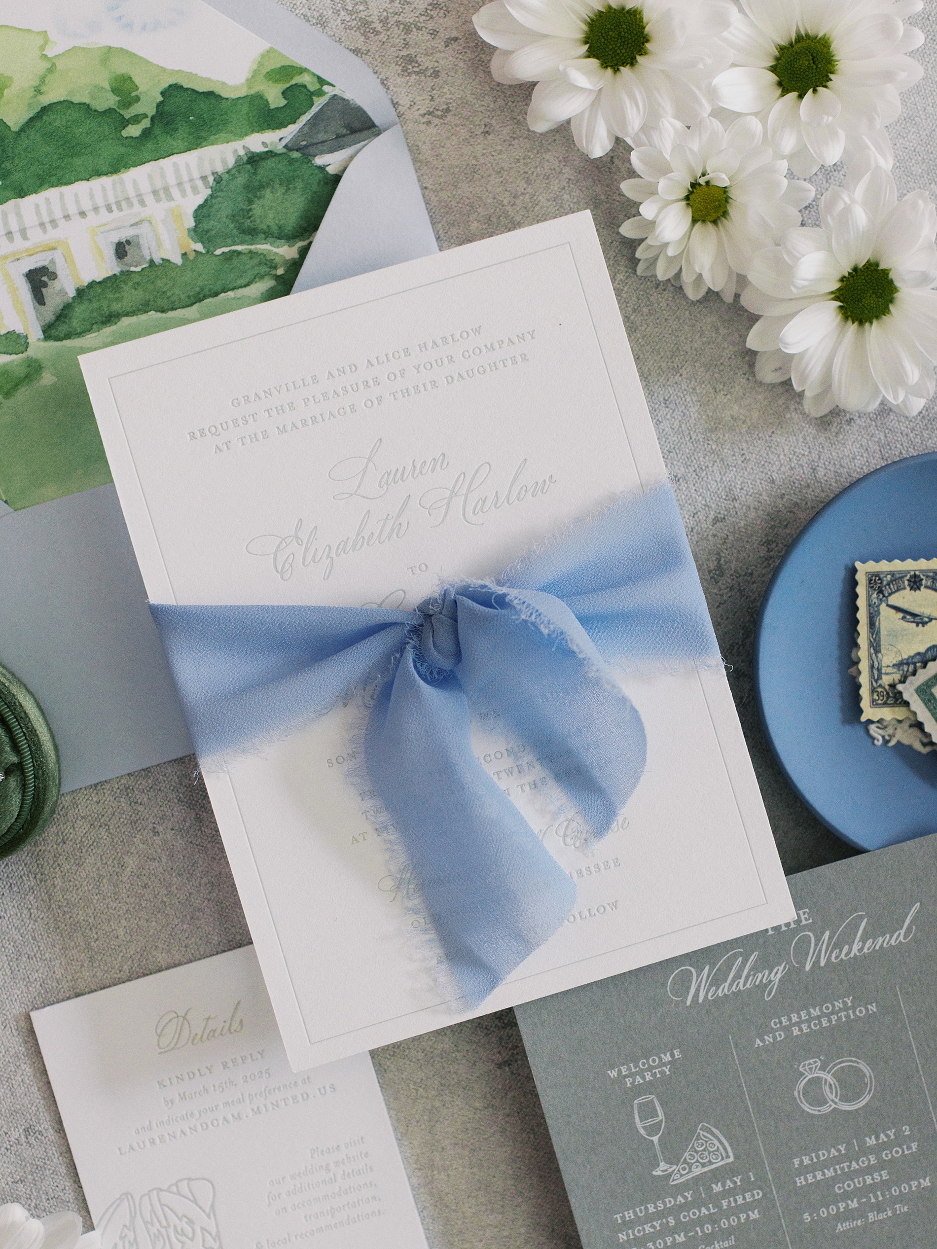 dusty blue ribbon around invitation