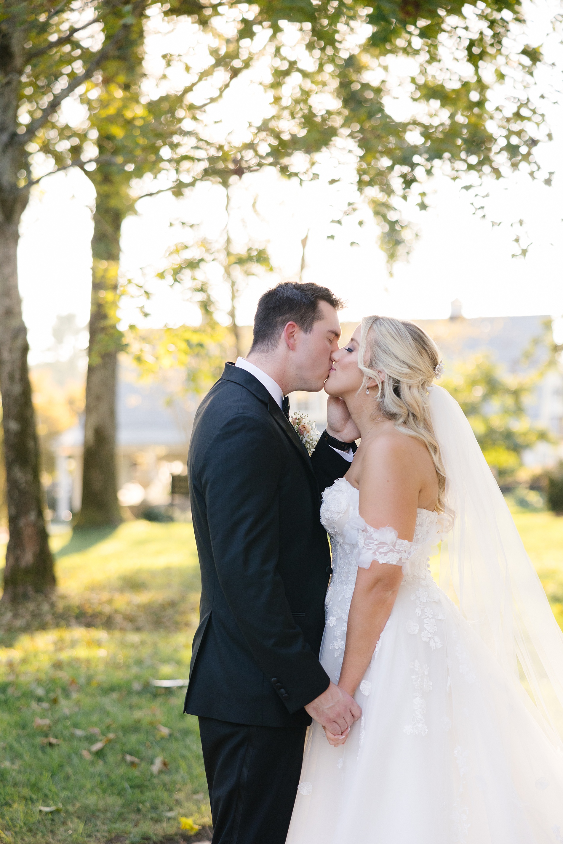 bride and groom kiss from Luxurious Fall Wedding at Cherokee Dock
