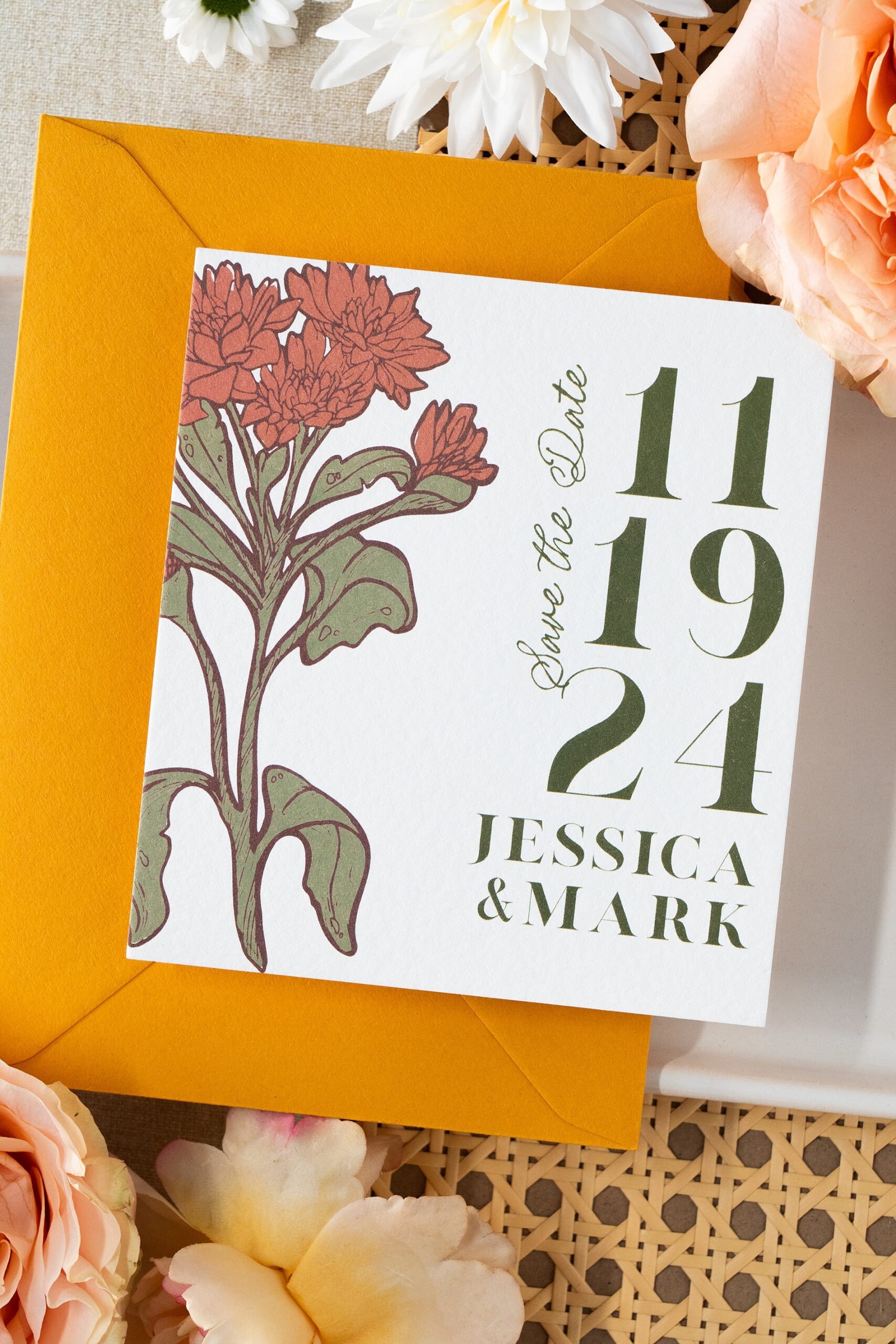 marigold yellow envelope with custom save the date on top featuring an image of a marigold flower