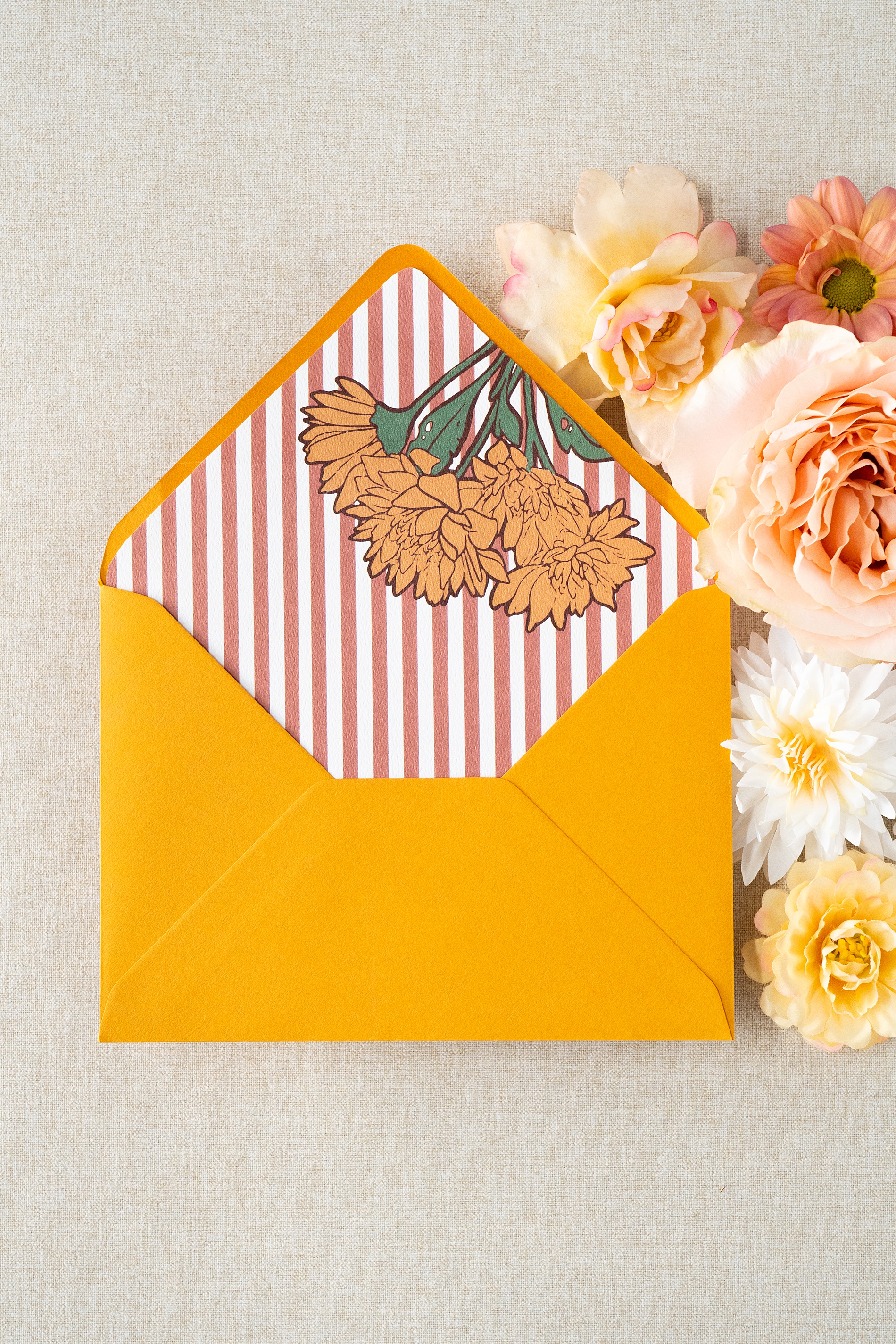 yellow envelop with custom envelope liner of pink stripes and marigold flowers | Wedding Invitations That Pop