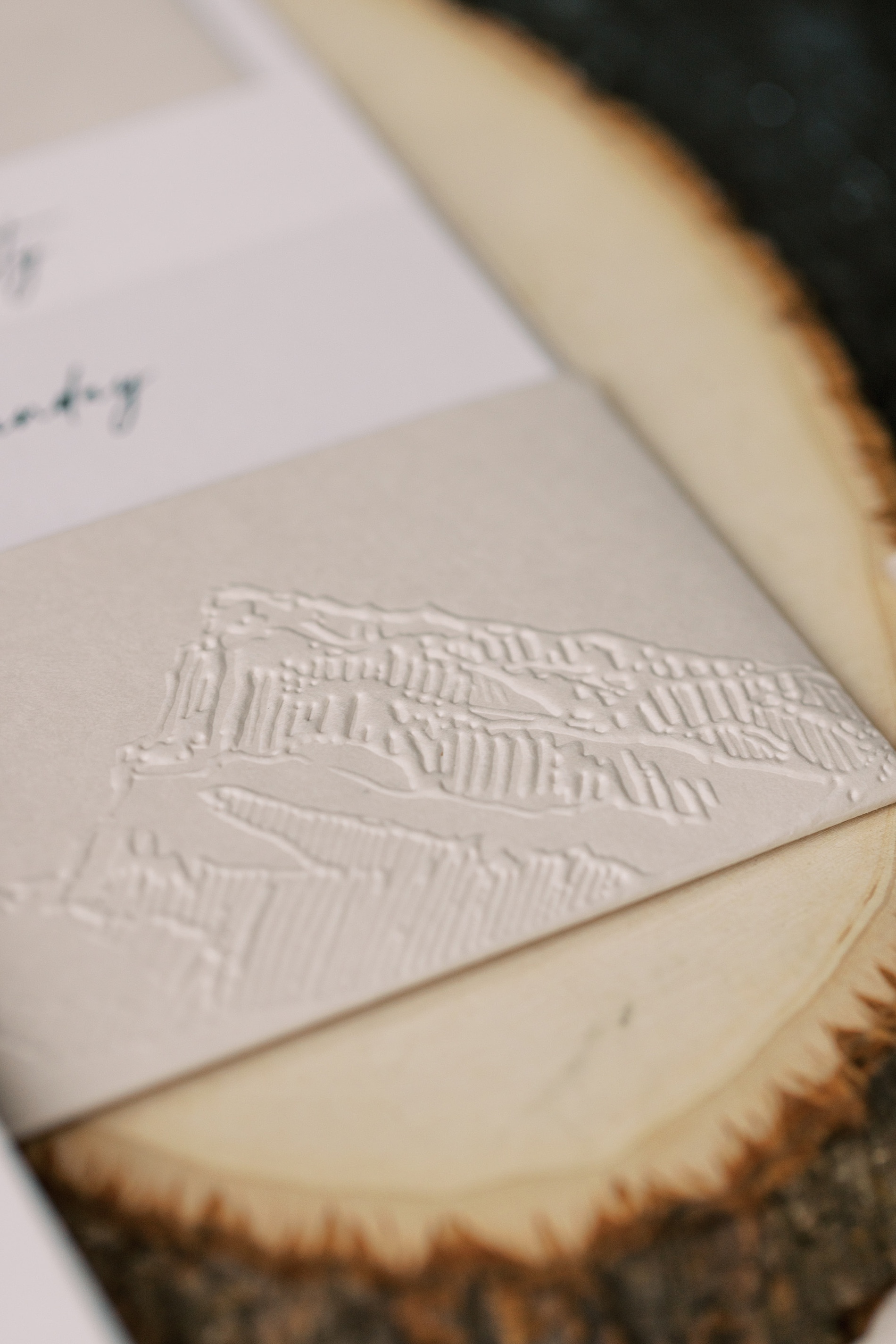 embosses raised mountain scape on invitation pocket from Western-Inspired Wyoming Ranch Wedding 