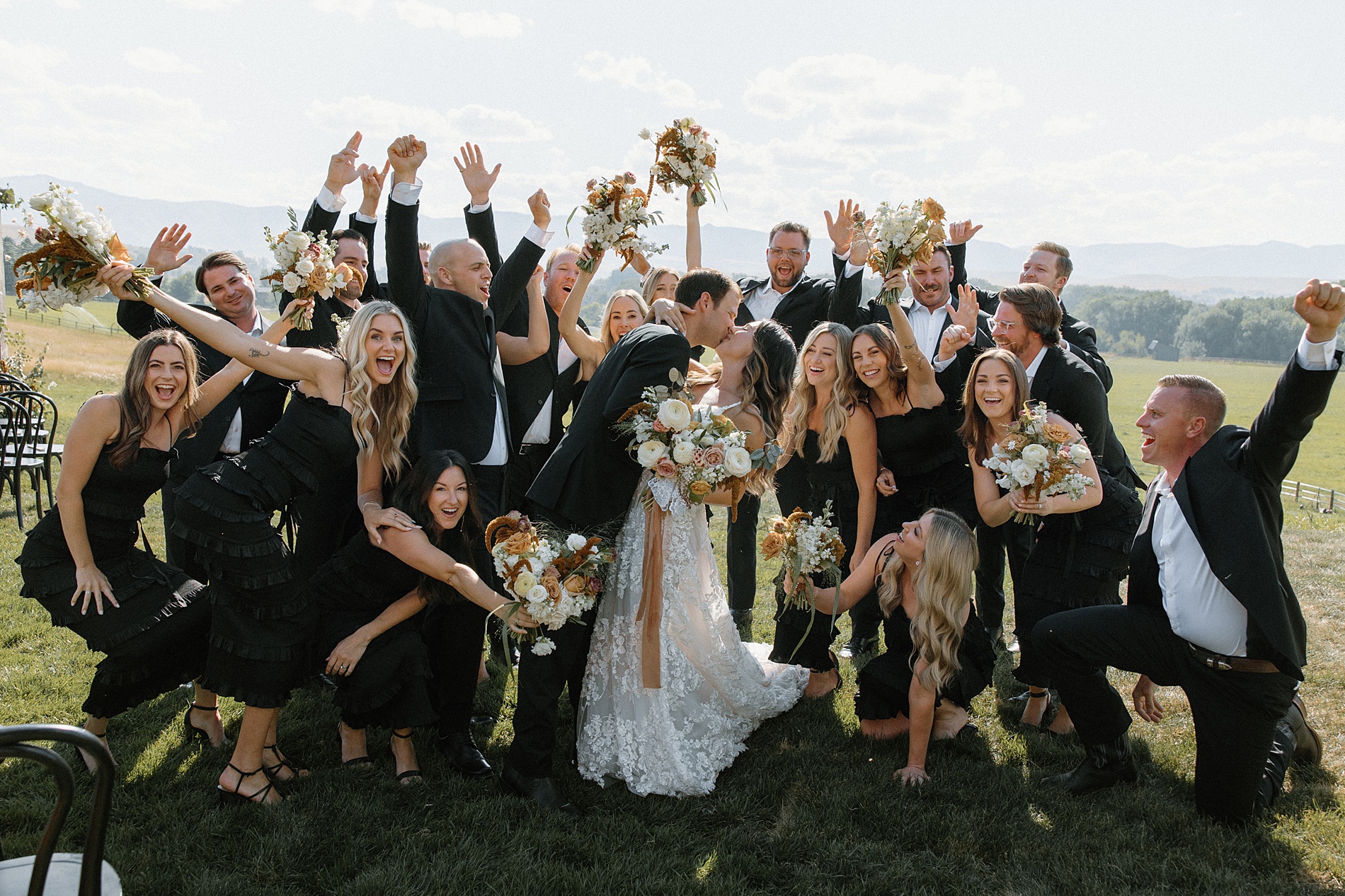 wedding party surrounds bride and groom 