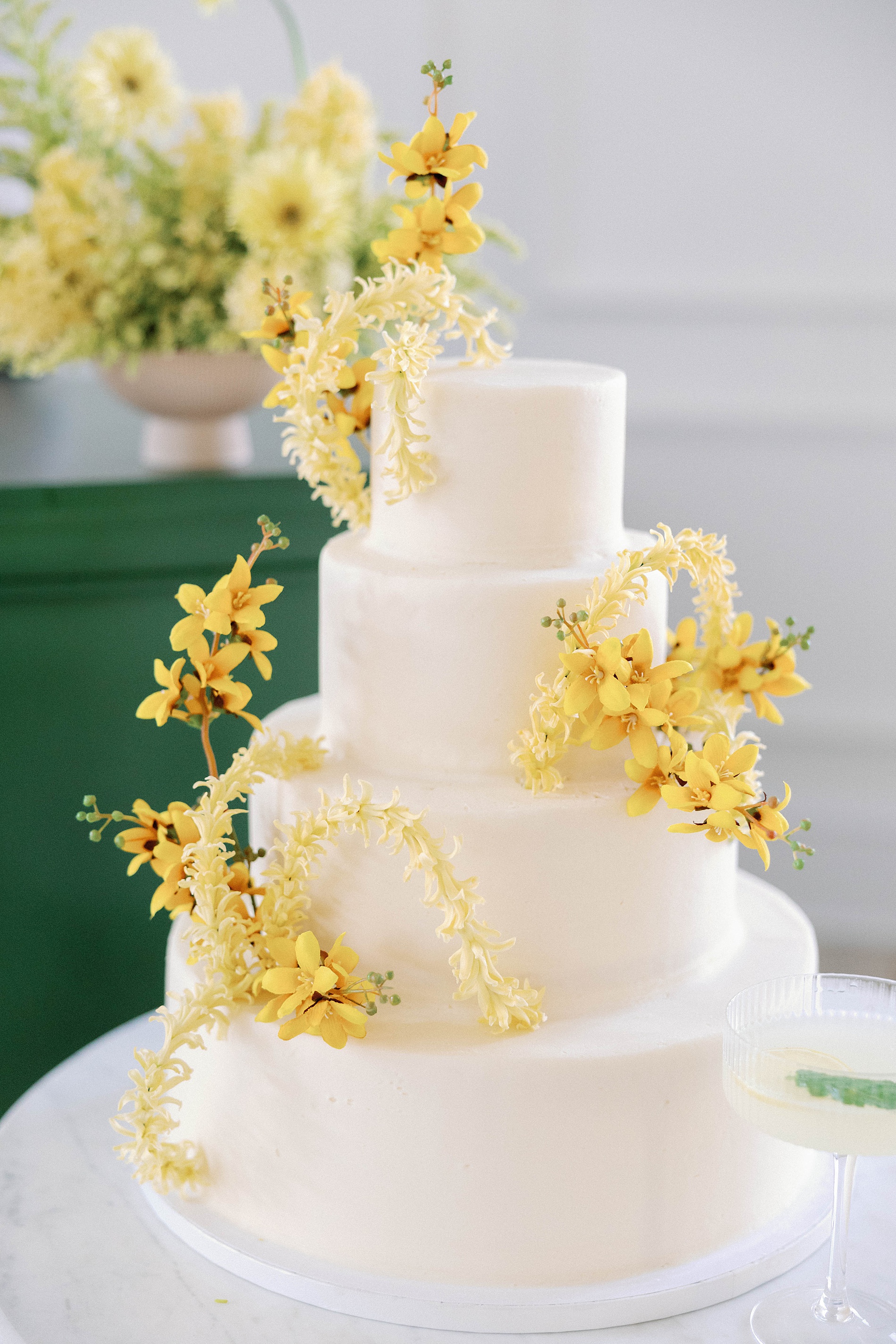 elegant white wedding cake decorated with yellow flowers