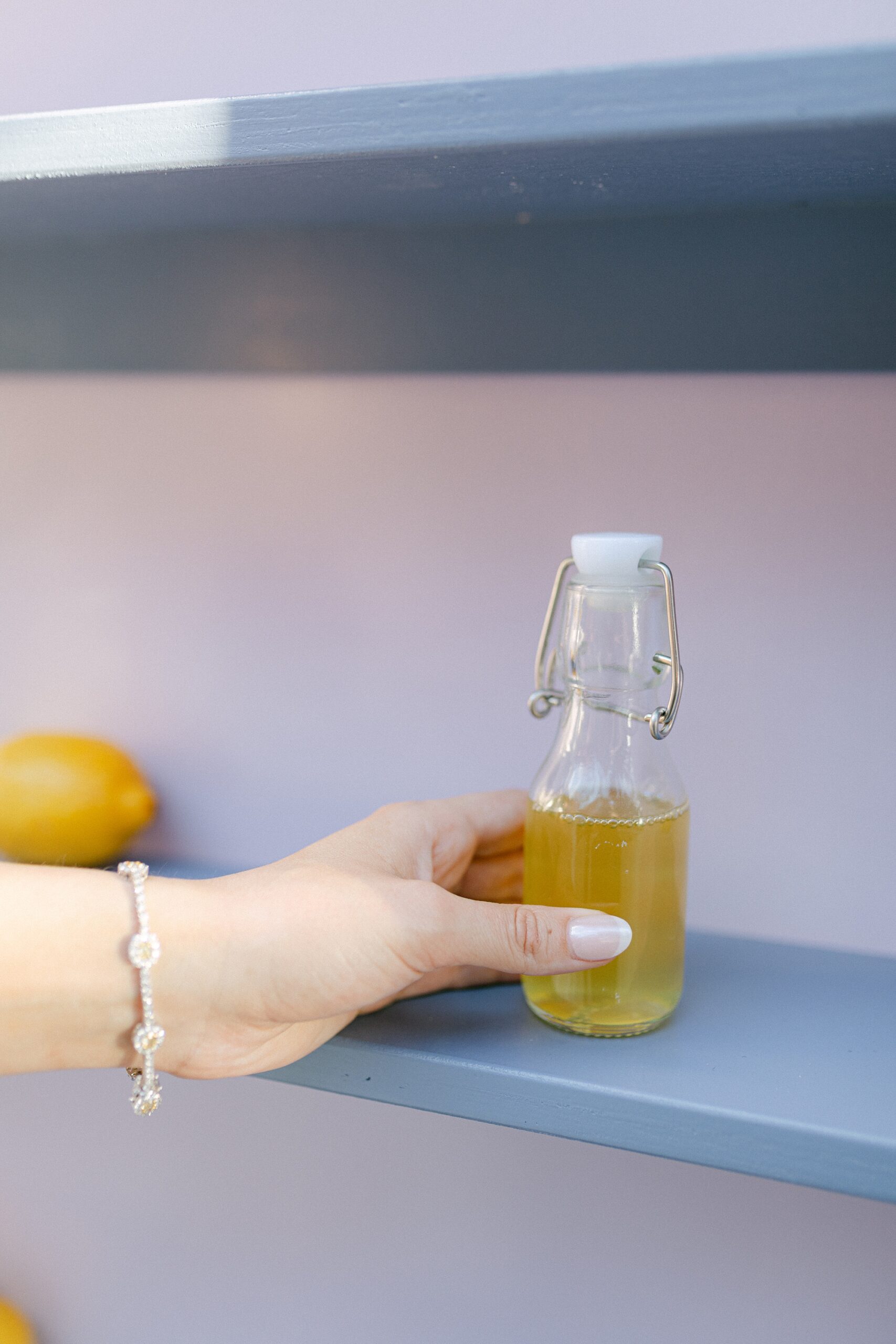 hand grabs bottle of limoncello 