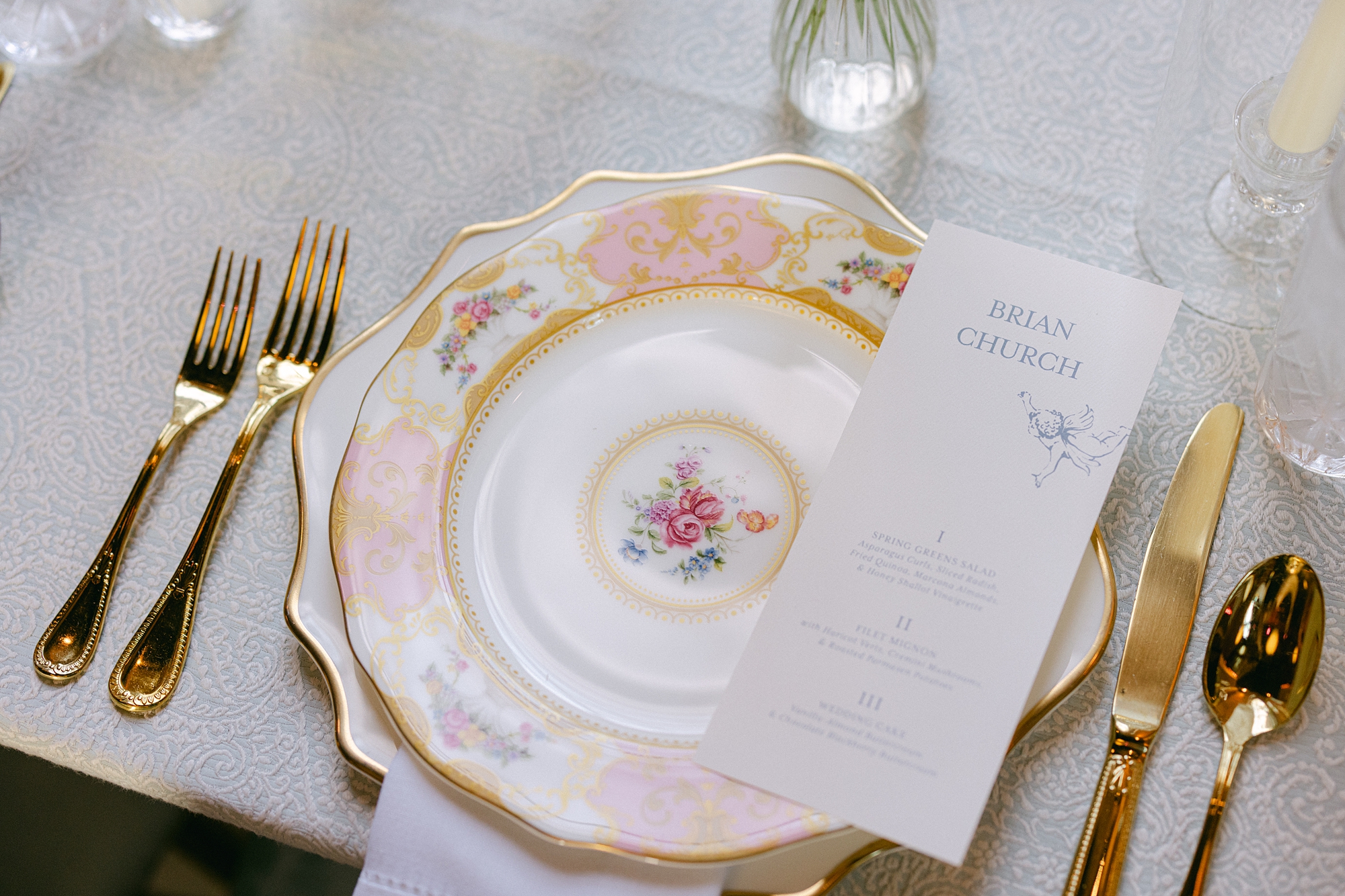 wedding menus on pink floral patterned plate 