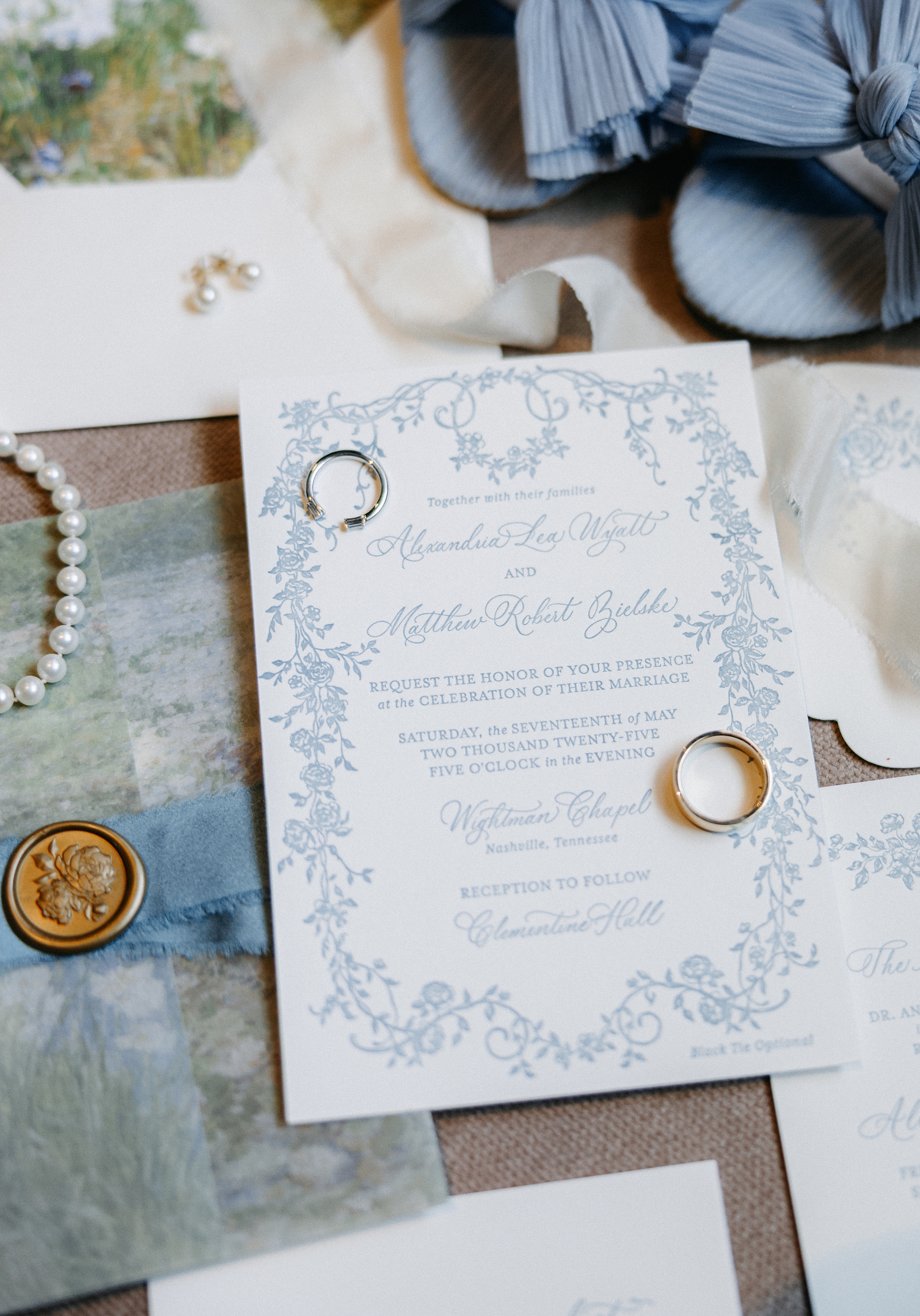 letter-pressed invitation with blue vine border