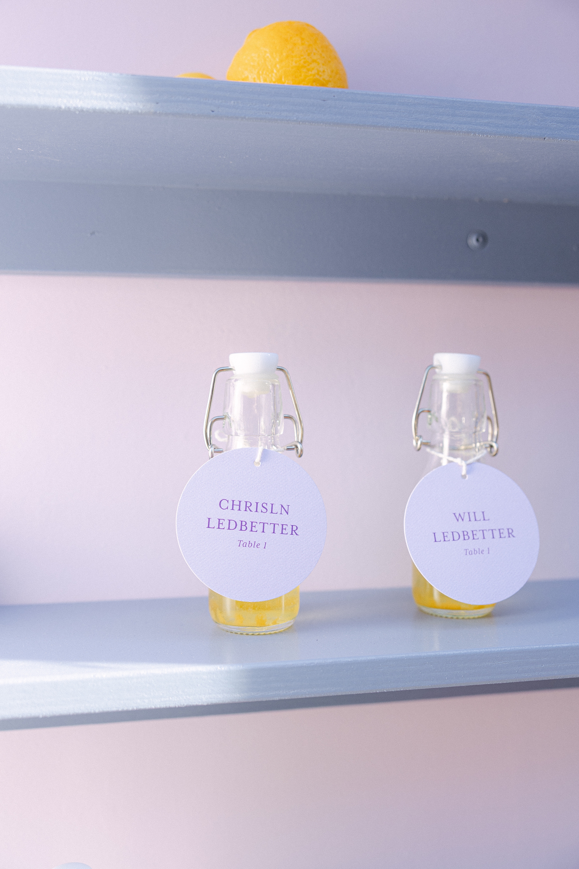 bottles of limoncello with circular escort tags