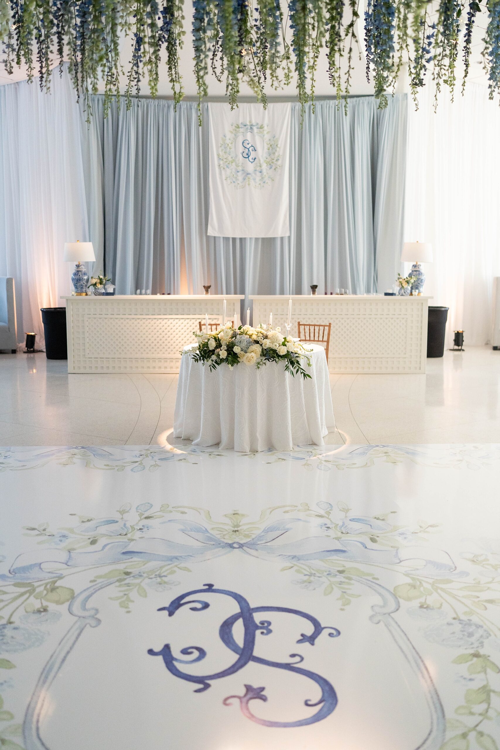 Elegant Spring Wedding Details at wedding reception with custom floor wrap 