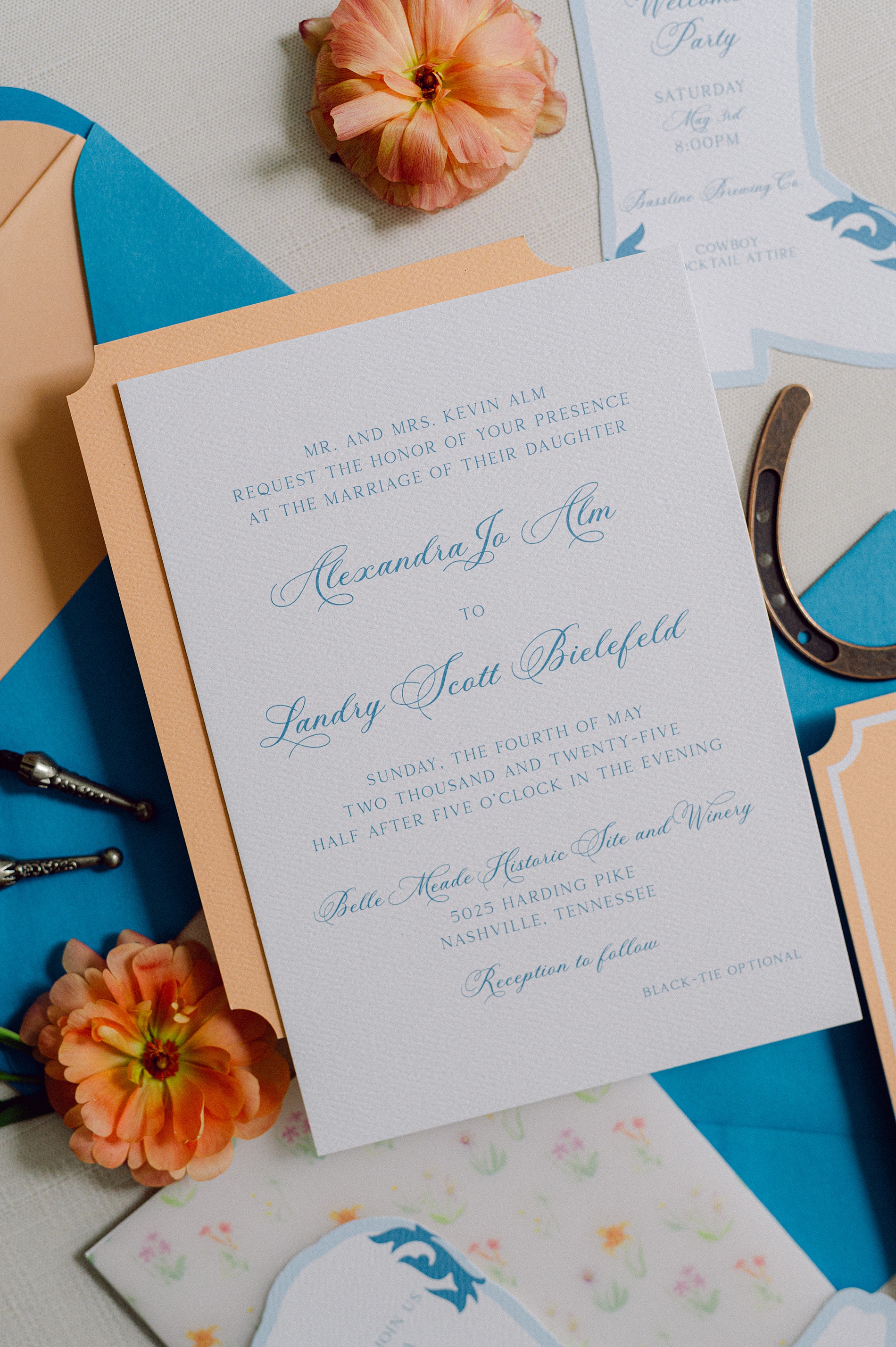 white and blue wedding invitation with pops of sherbet orange 